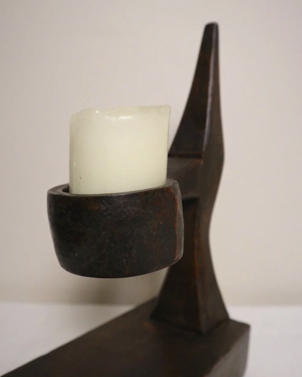 American hand carved dark wooden Brutalist candleholder with block base.