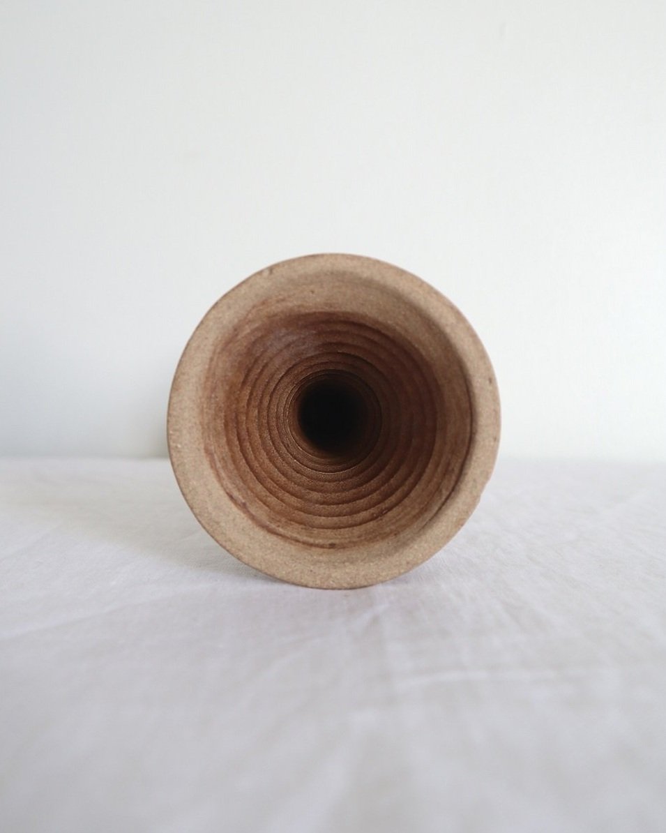 Rustic handmade studio pottery sculptural candleholder with curled circular handle.