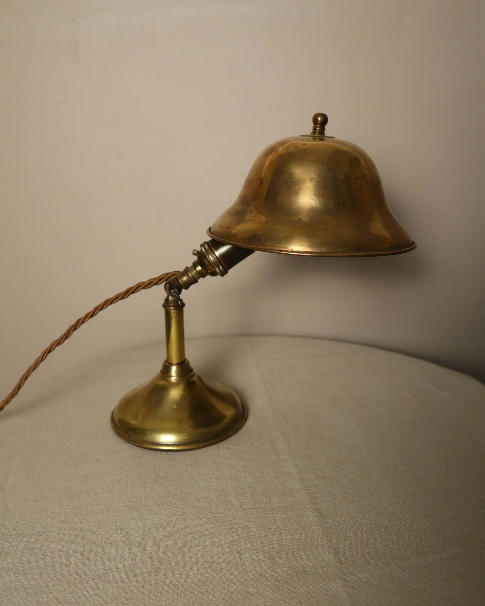 Small, vintage adjustable brass worker's desk lamp. Can be freestanding or attached to the edge of a workbench etc with clamp.