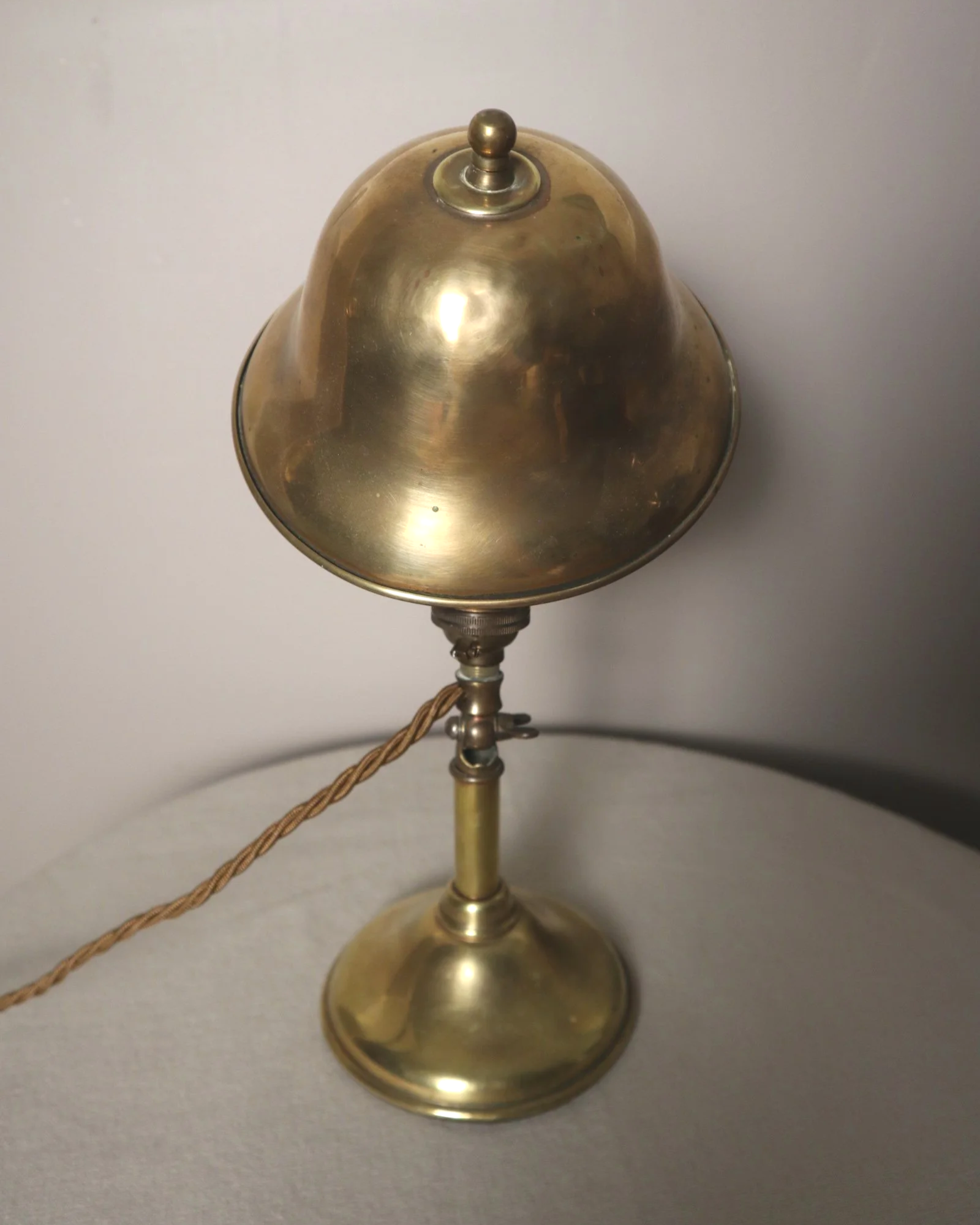 Small, vintage adjustable brass worker's desk lamp. Can be freestanding or attached to the edge of a workbench etc with clamp.