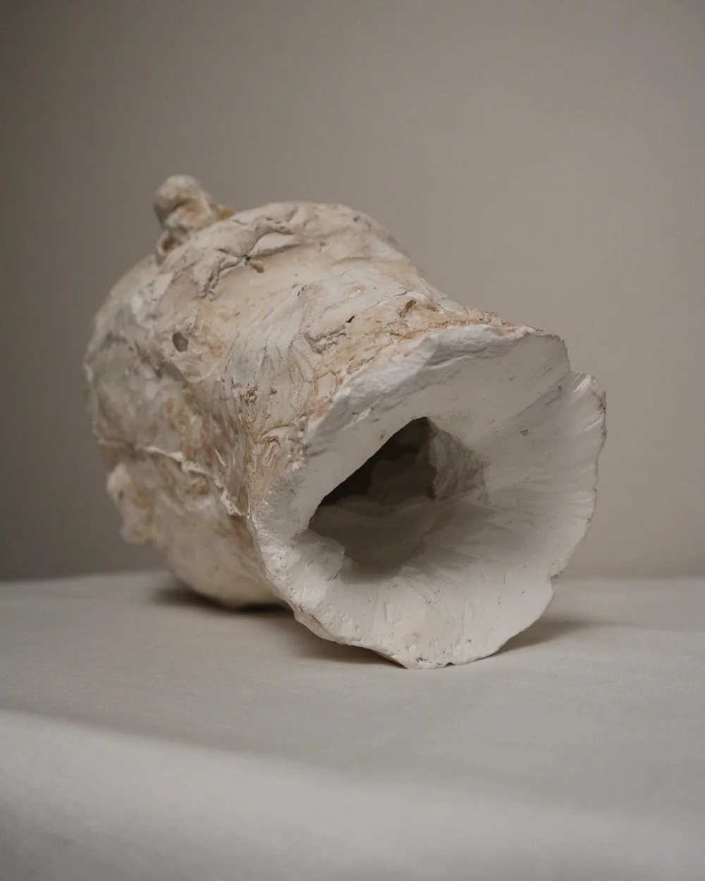 Large, heavy off white textured plaster sculpture of man's head in abstract style. Unknown age.