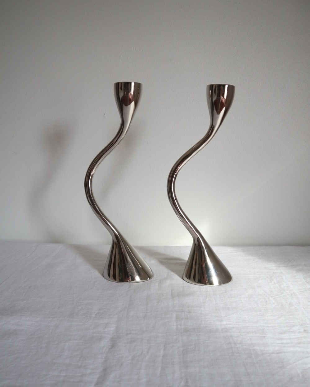Pair of sculptural solid aluminium candleholders, circa 1970s.