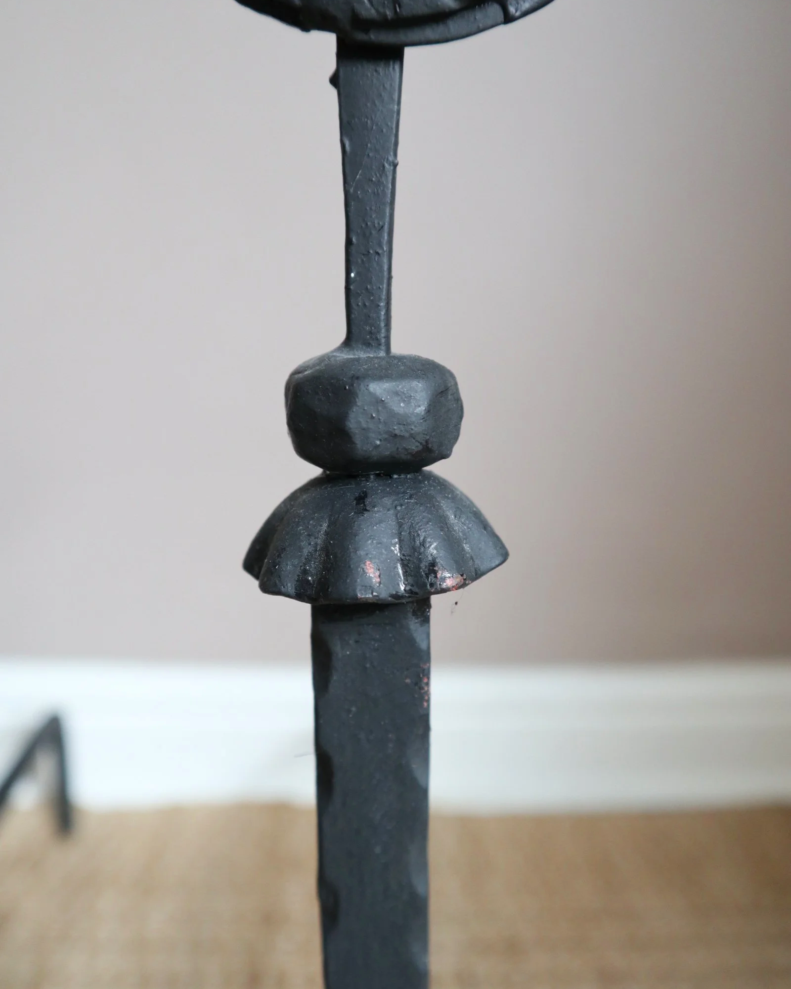 Pair of black wrought-iron andirons or firedogs featuring stylized rooster finials, circa mid-20th century.