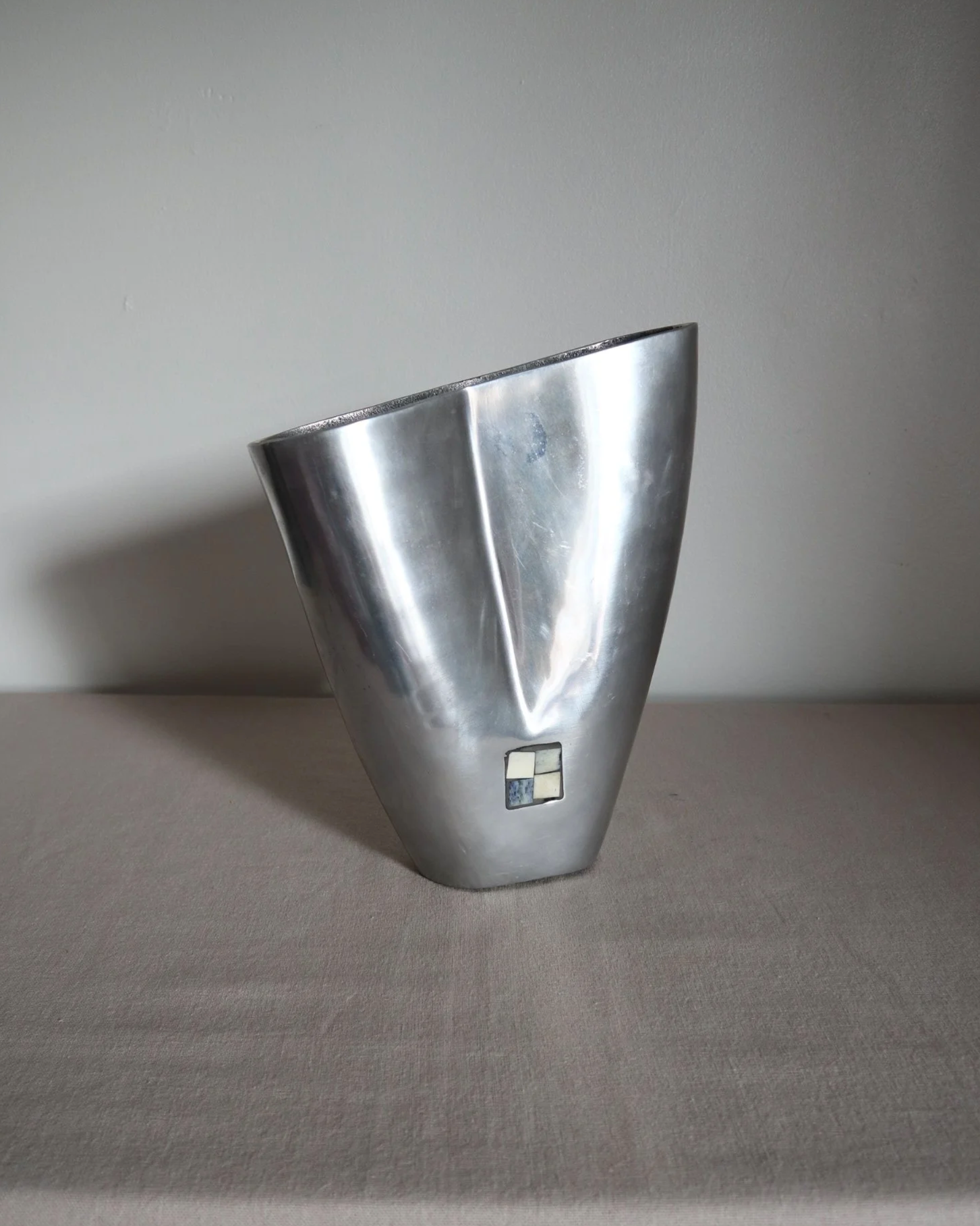Postmodern heavy cast aluminium vase with sculptural form and four small inset stones. In the style of Anna Efverlund. Circa 1980s. Unsigned.