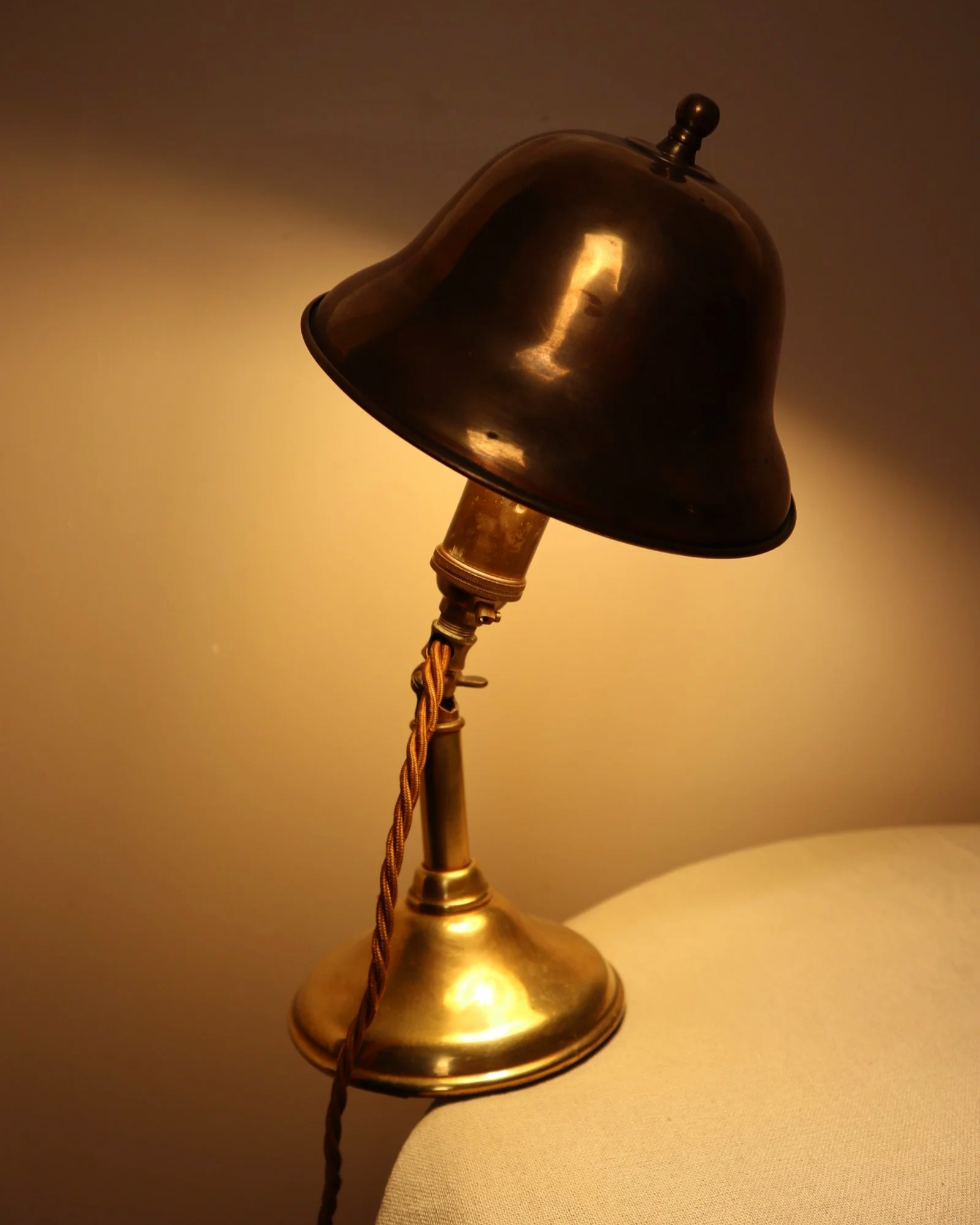 Small, vintage adjustable brass worker's desk lamp. Can be freestanding or attached to the edge of a workbench etc with clamp.