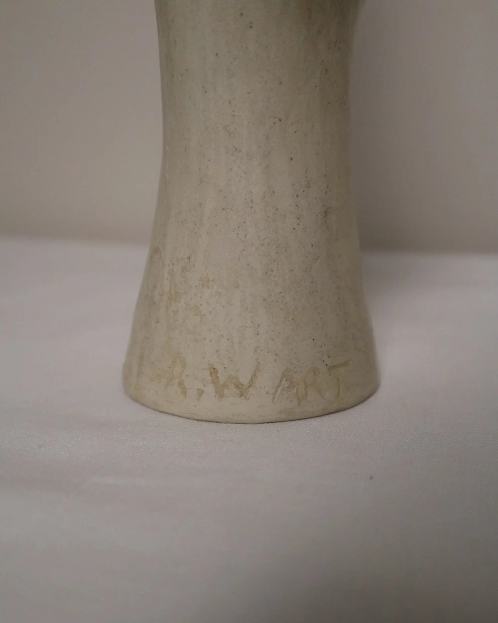 Set of three white ceramic abstract sculptures in the shape of the female form. Unknown age.  Signed 'R W Art / RoseWood Art'