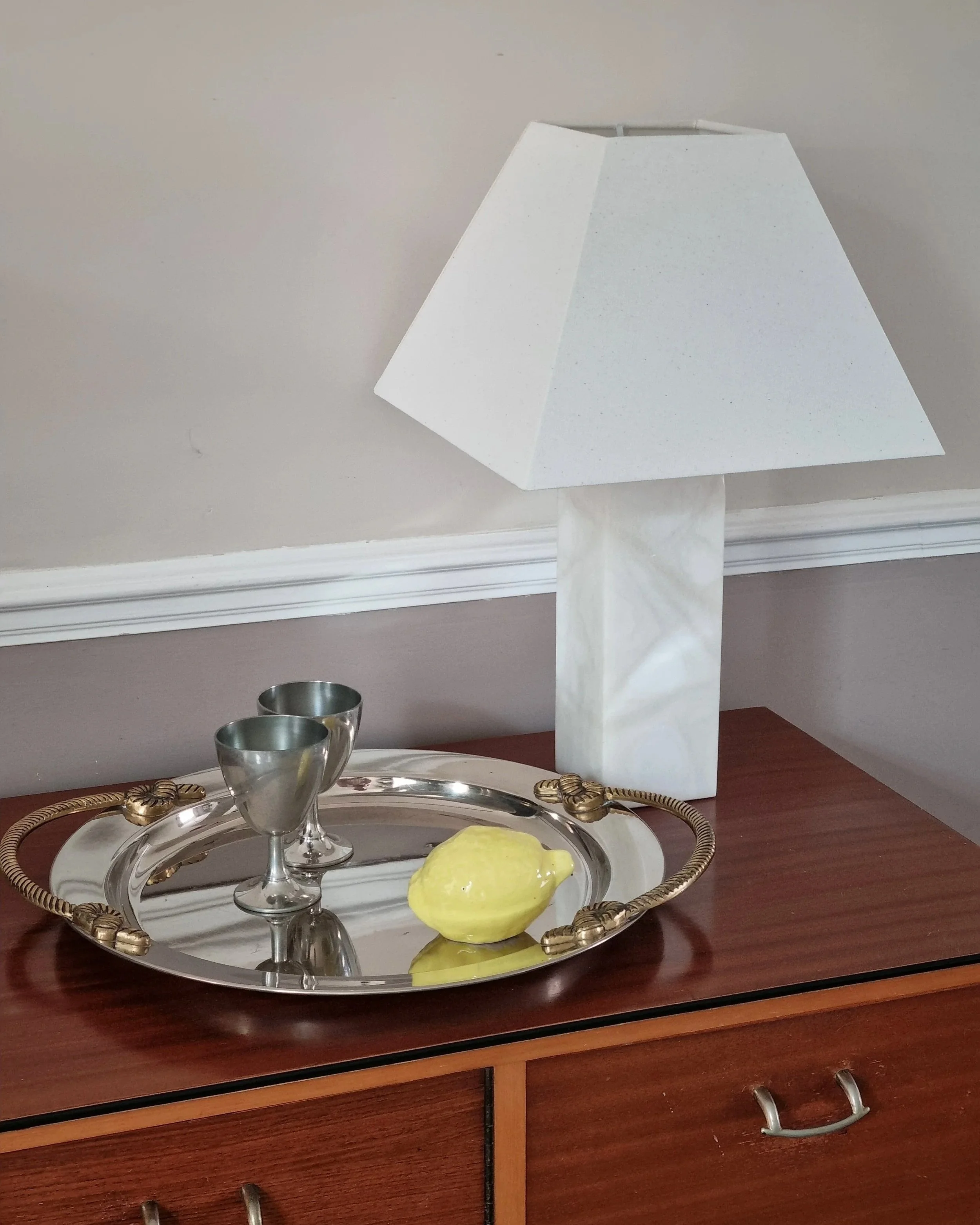Large mid century circular shiny metal serving tray with elegant brass rope design handles.