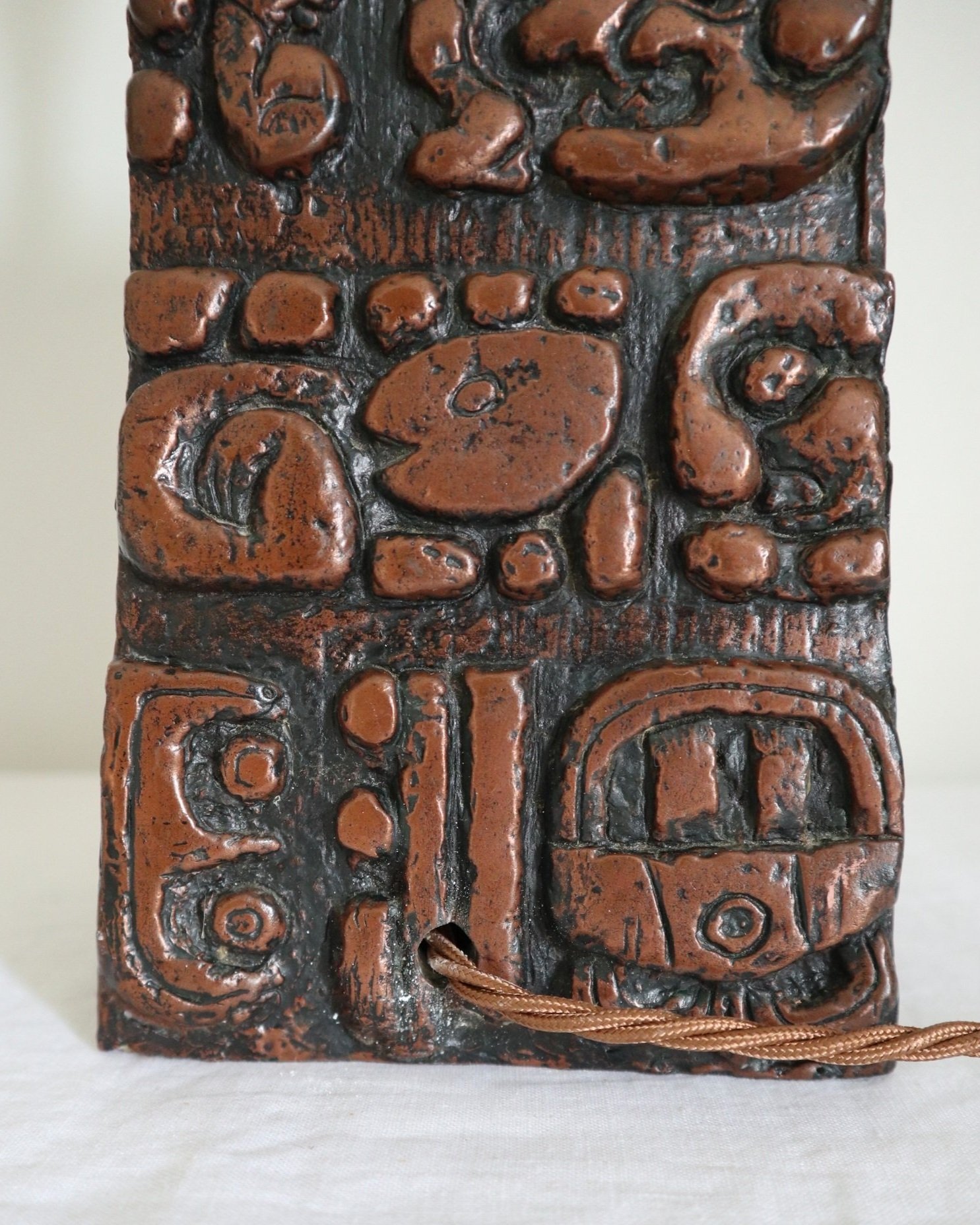 Mid century very heavy Brutalist Aztec style cast resin table lamp with metallic bronze finish.
