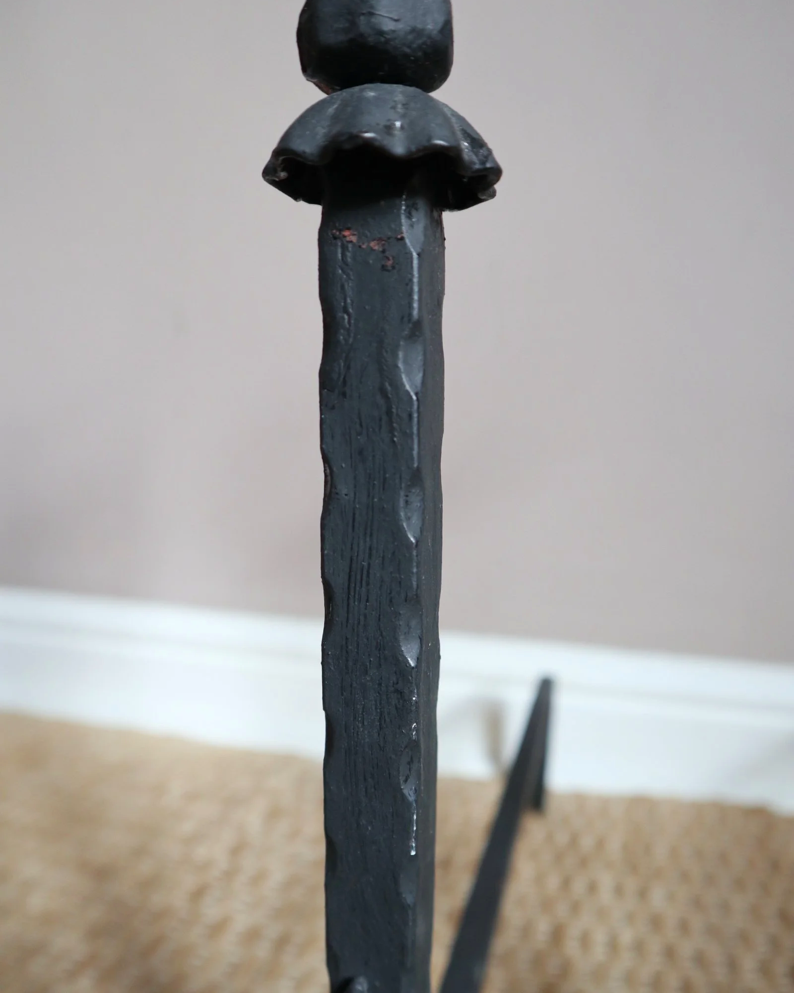 Pair of black wrought-iron andirons or firedogs featuring stylized rooster finials, circa mid-20th century.