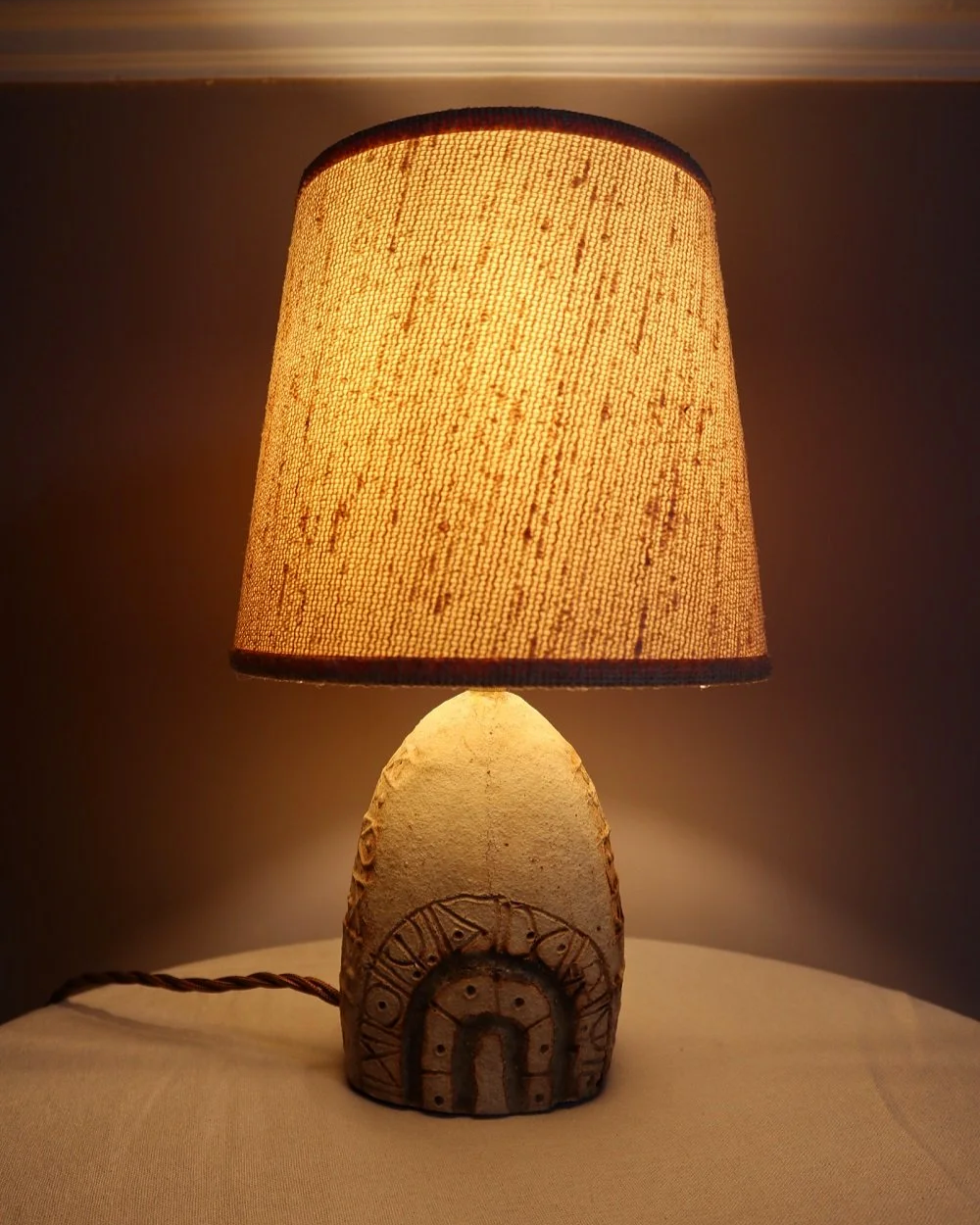 Small Brutalist stoneware table lamp by British potter Bernard Rooke. With stamped, rune-like impressions. Circa 1970s.