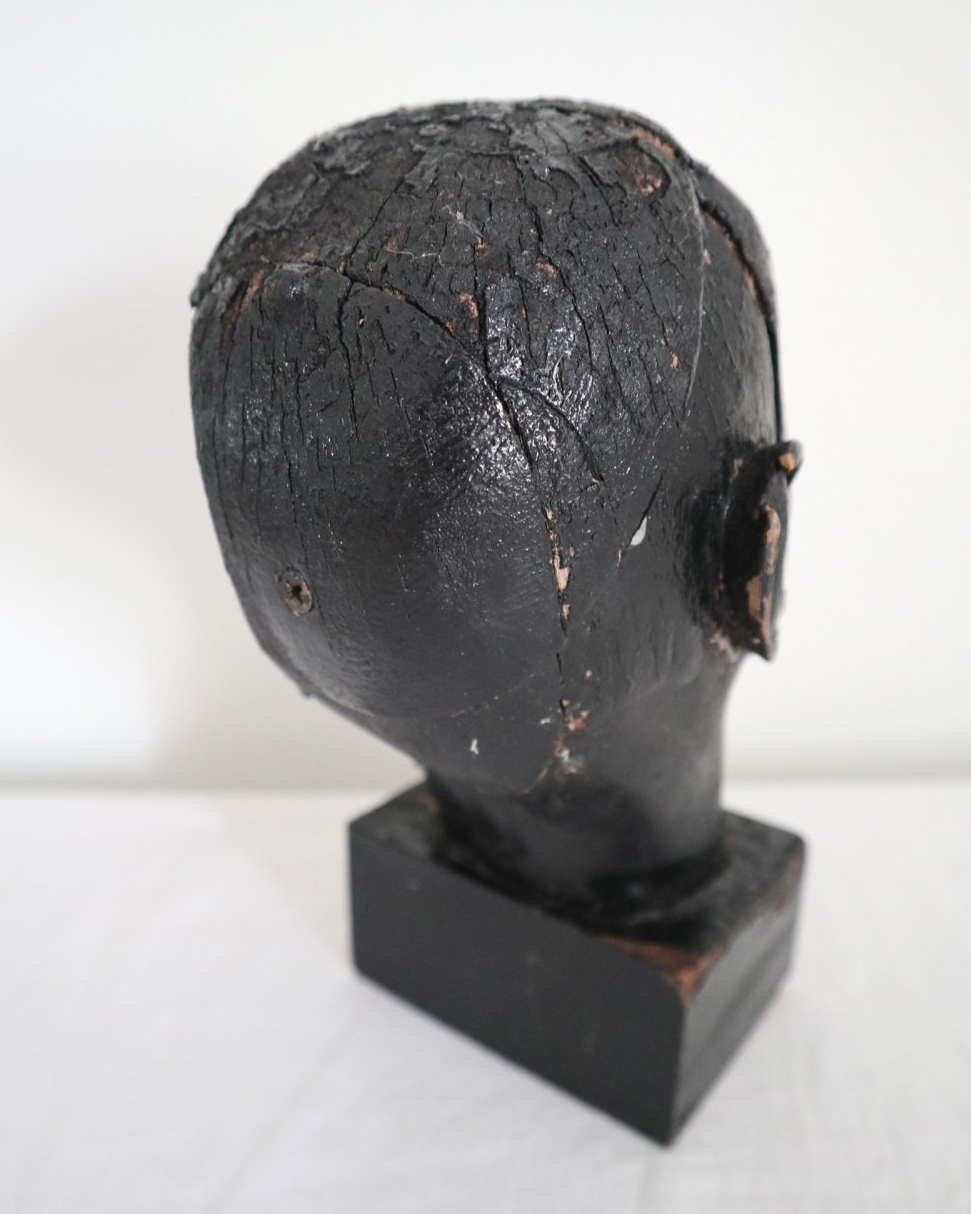 Vintage hand carved black painted wooden sculpture of male head. Age unknown.