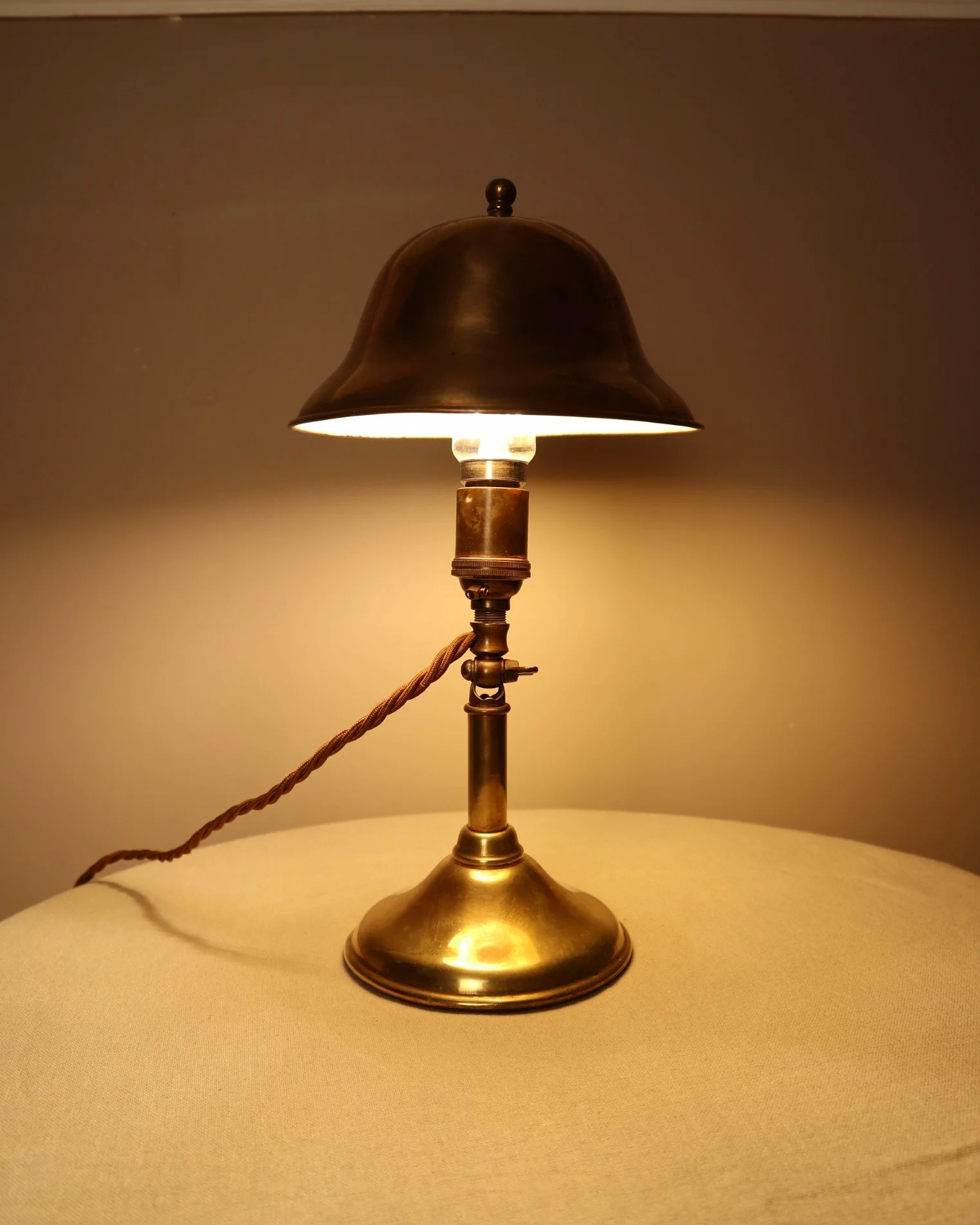 Small, vintage adjustable brass worker's desk lamp. Can be freestanding or attached to the edge of a workbench etc with clamp.