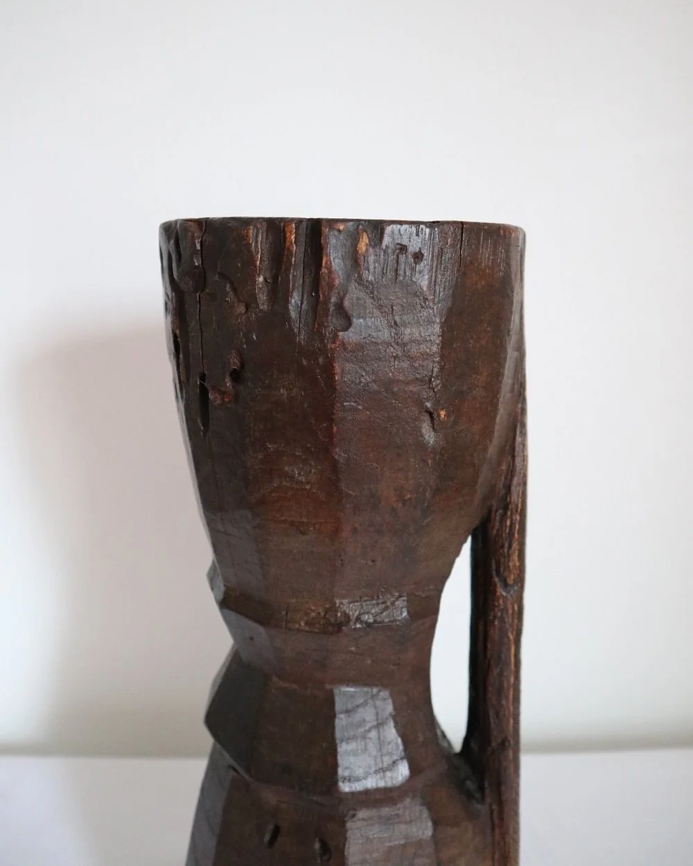 Heavy primitive sculptural carved wooden mortar with handle.