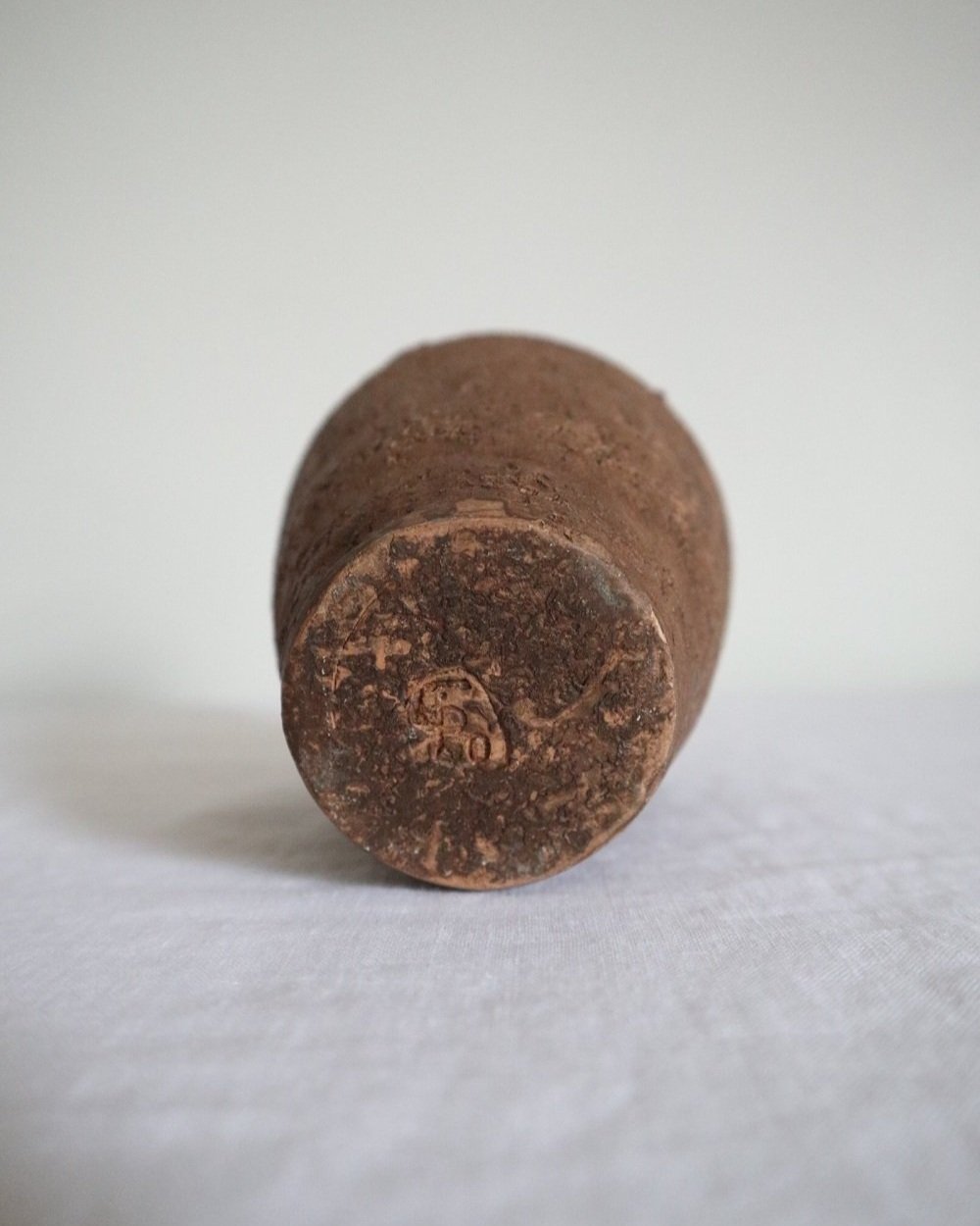 Mid century Brutalist sculptural textured brown ceramic decorative vessel or bud vase. Circa 1970s. Signed “CP”, likely the work of American potter Karl Martz for Clayburn Pottery.
