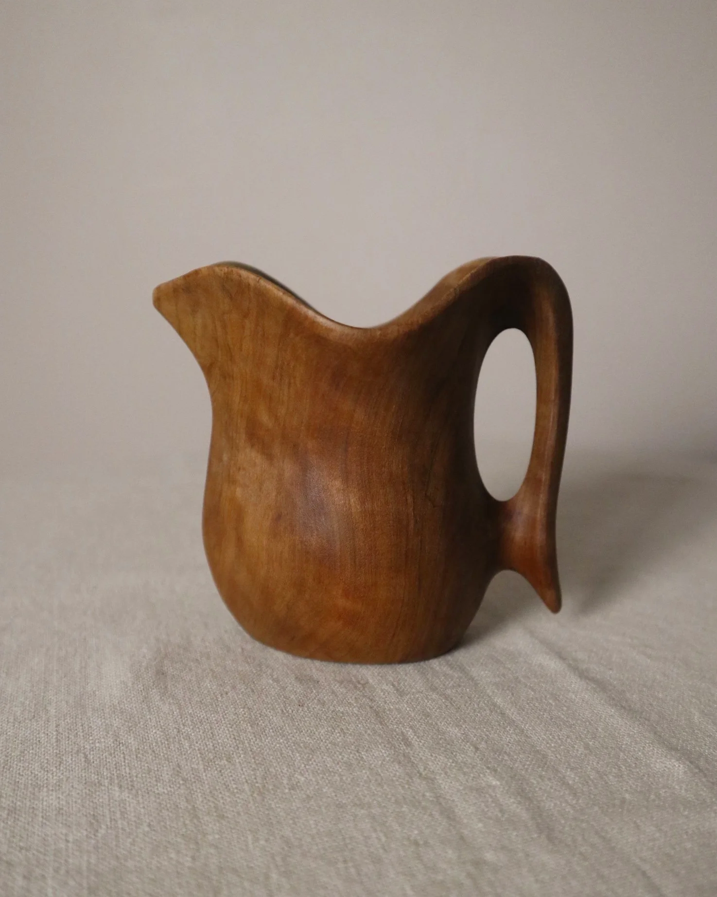Small mid century hand carved sculptural olivewood jug in the style of Alexandre Noll. Circa 1960s.