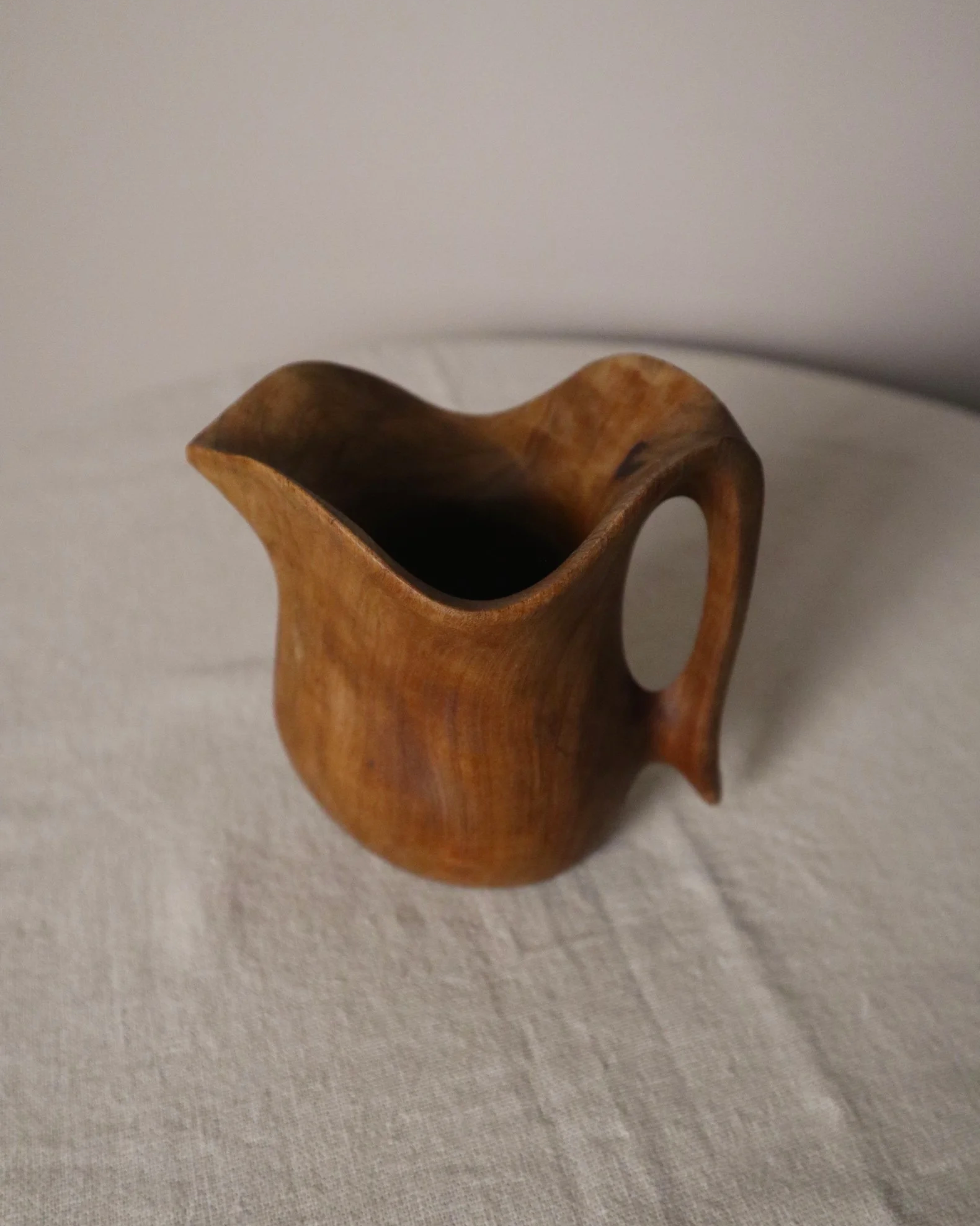 Small mid century hand carved sculptural olivewood jug in the style of Alexandre Noll. Circa 1960s.