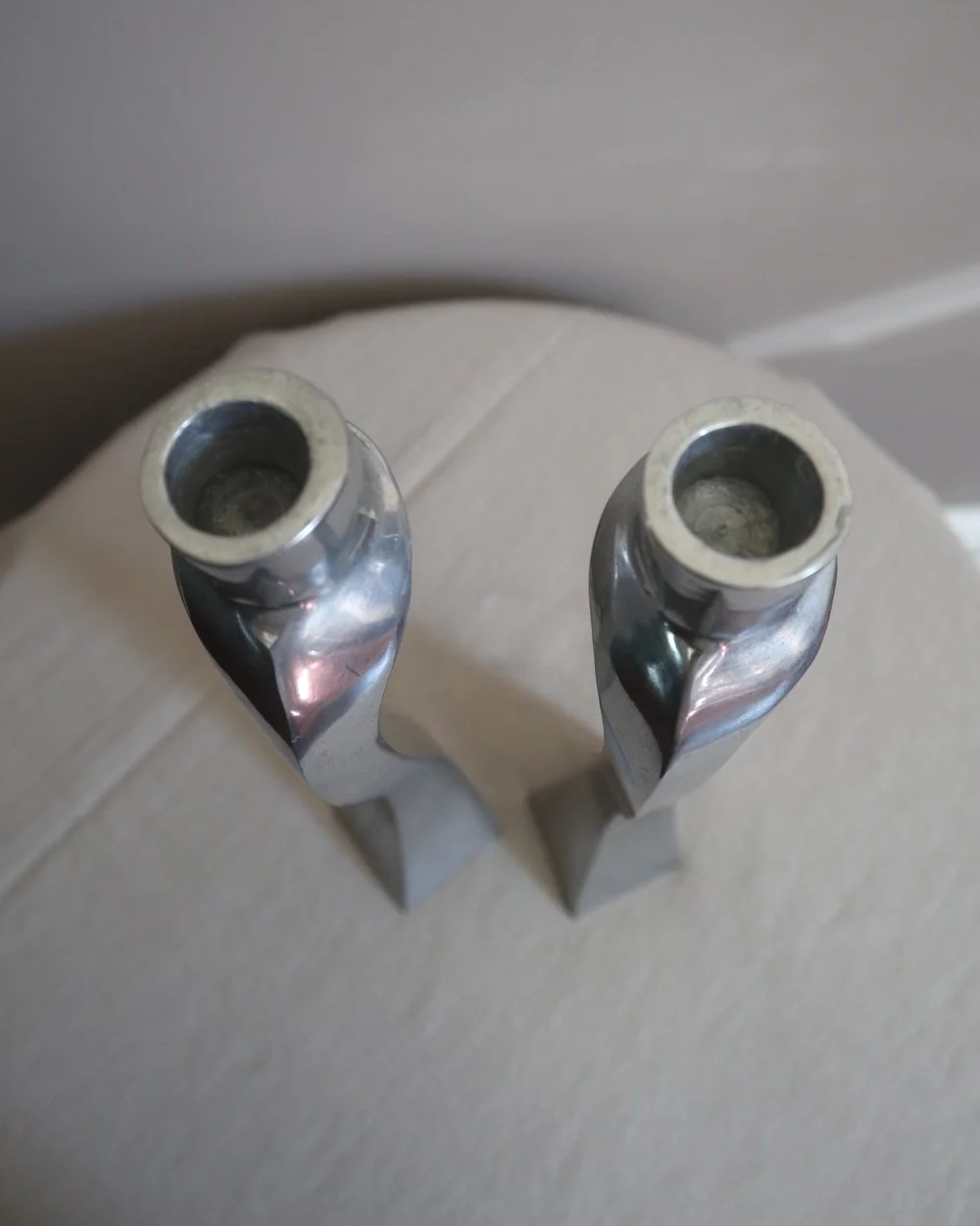 Pair of tall, elegant 1980s Modernist cast aluminium candleholders, likely 'Nessie' style designed by Matthew Hilton.