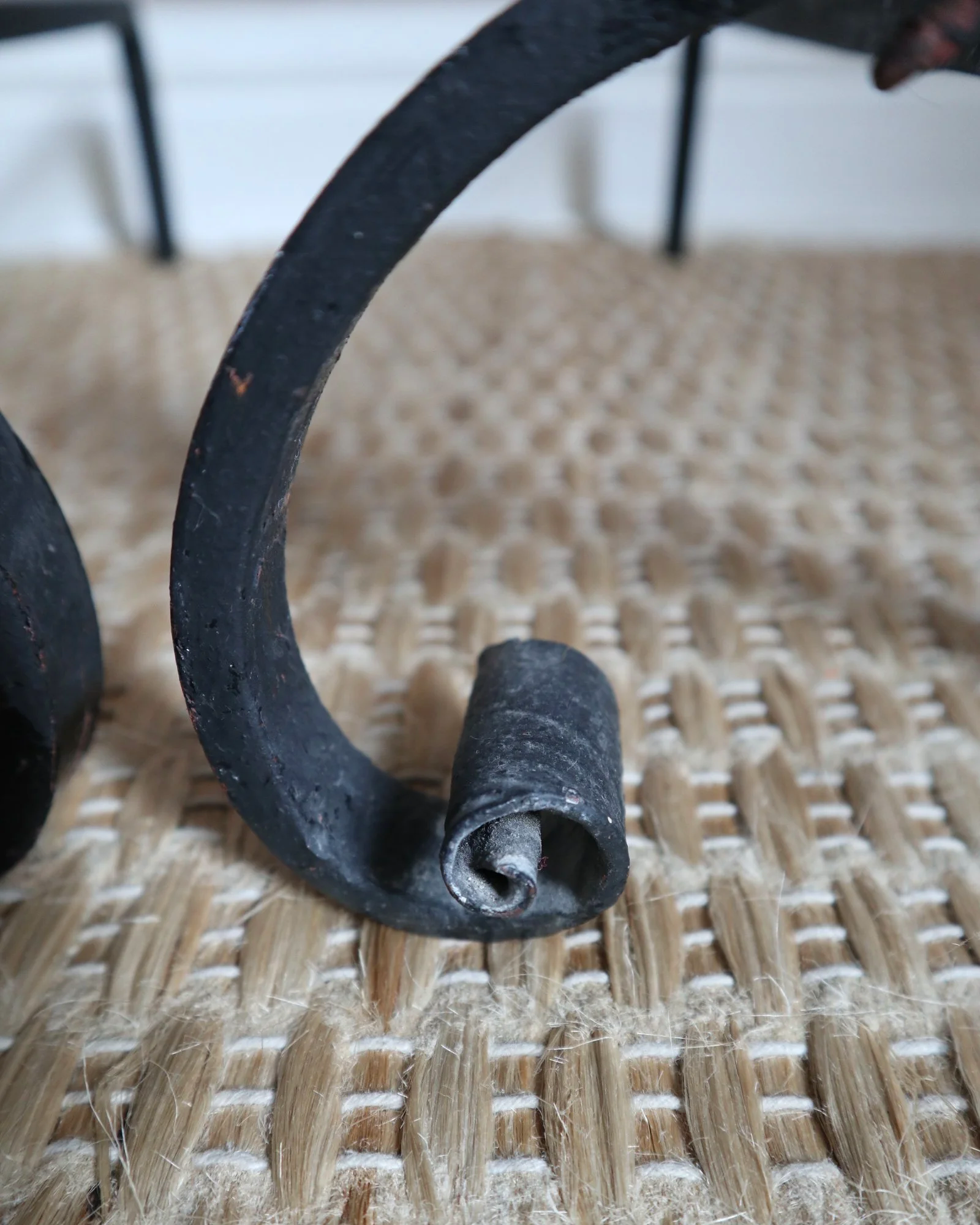 Pair of black wrought-iron andirons or firedogs featuring stylized rooster finials, circa mid-20th century.