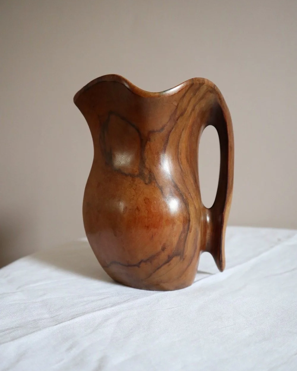 Small mid century hand carved sculptural olivewood jug in the style of Alexandre Noll. Circa 1960s.