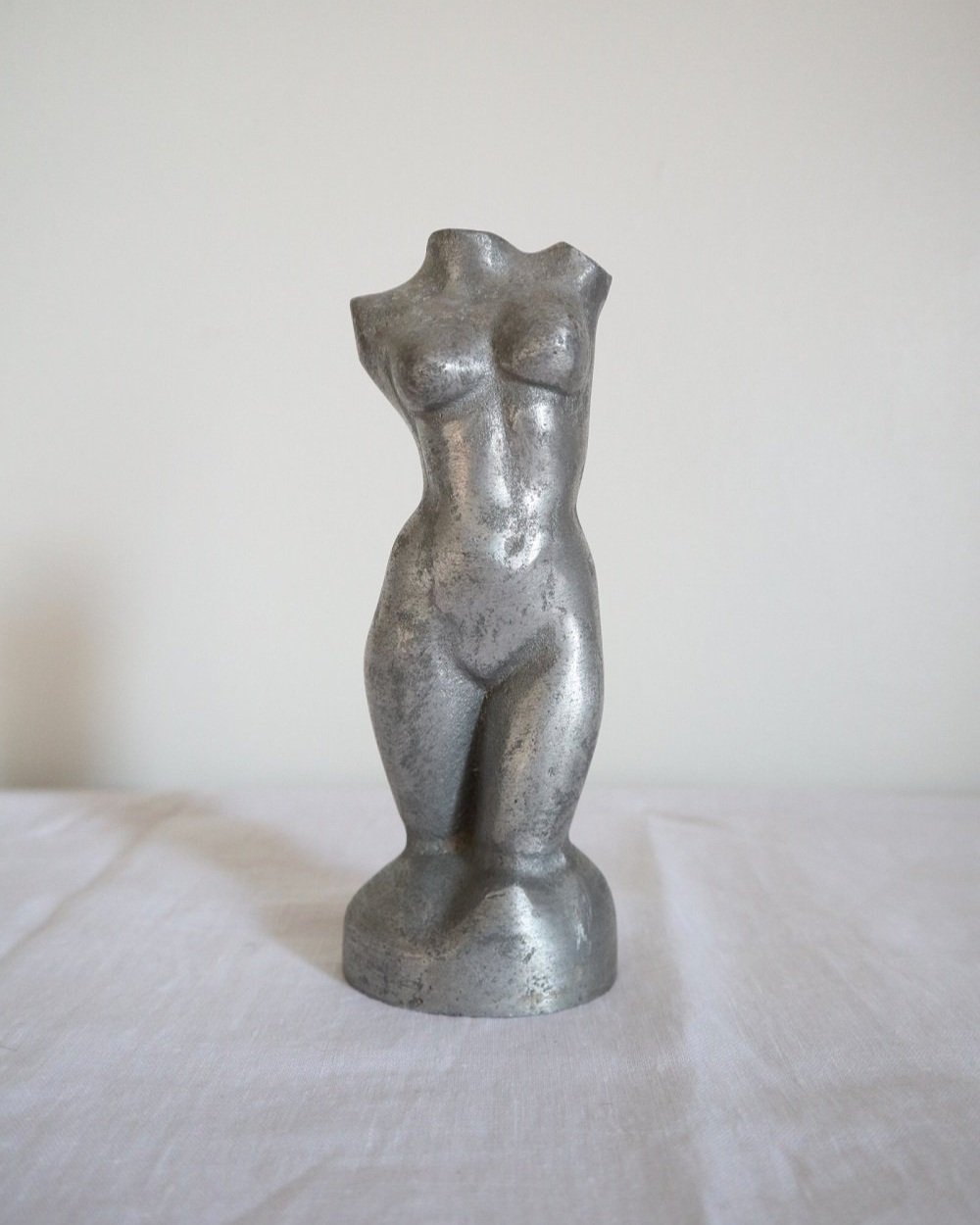Modernist cast aluminium naked torso sculpture.