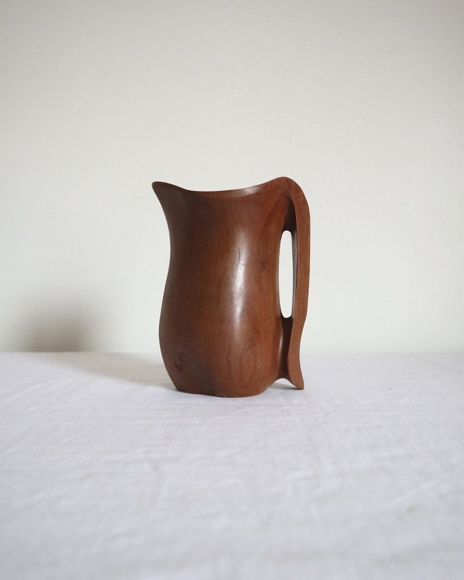 Small sculptural hand carved dark olivewood monoxyl pitcher, circa 1960/70s. In the manner of Alexandre Noll. Unsigned.
