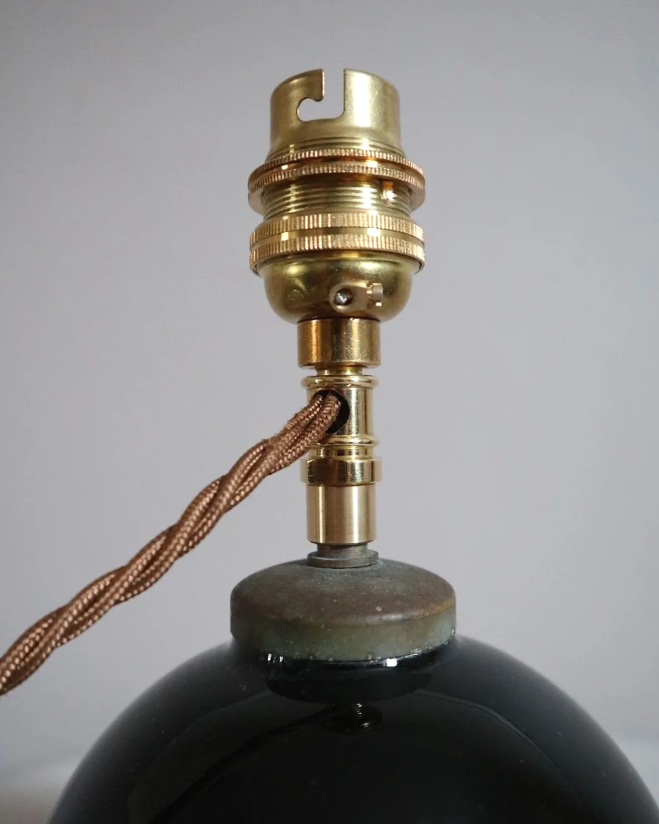 Small, Art Deco black glass ball lamp in the style of Jacques Adnet. Circa 1930s.