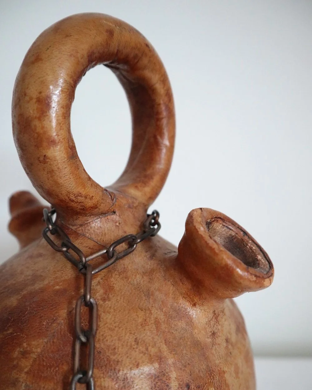 Spanish distressed tan leather covered oil or water pourer.