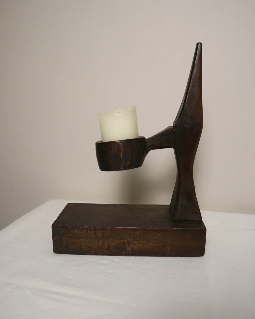 American hand carved dark wooden Brutalist candleholder with block base.
