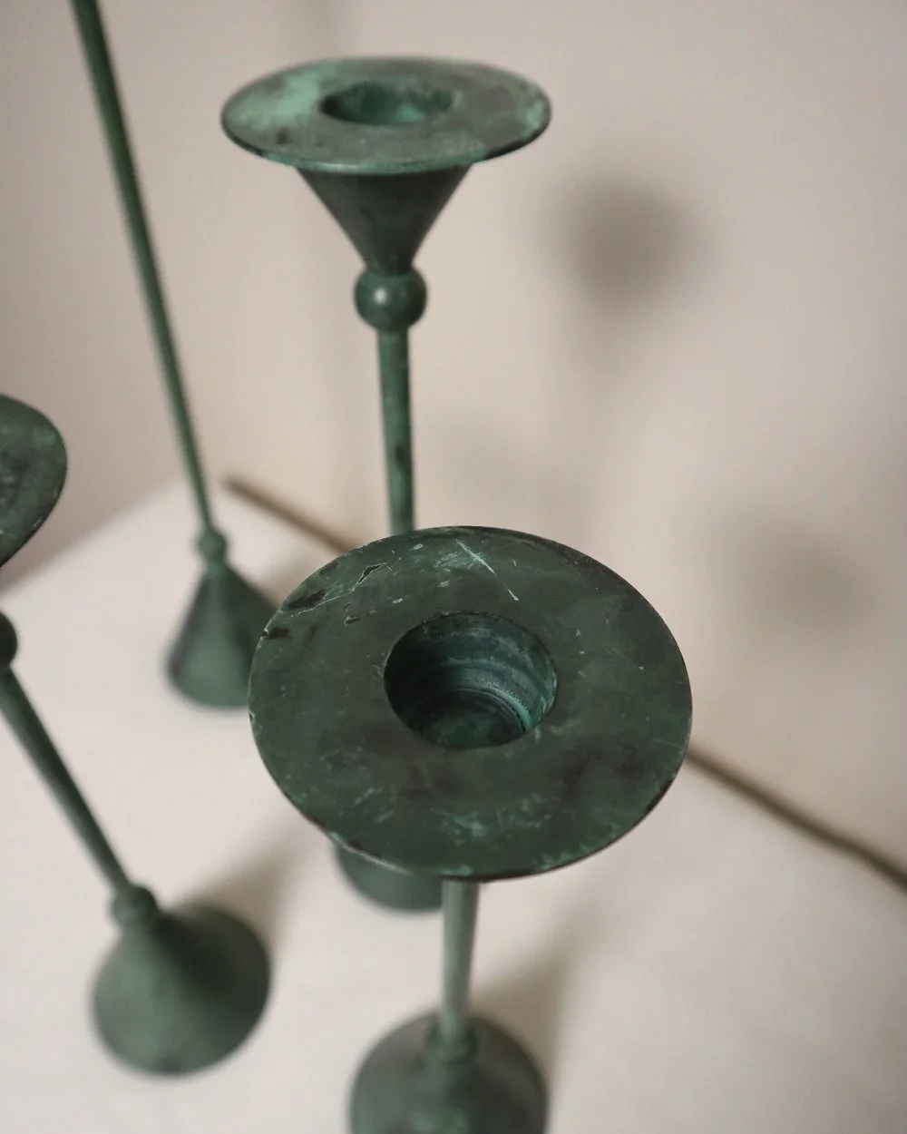 Set of 4 Postmodern verdigris metal candleholders, circa 1980s. In the Memphis style of Christian de Beaumont.