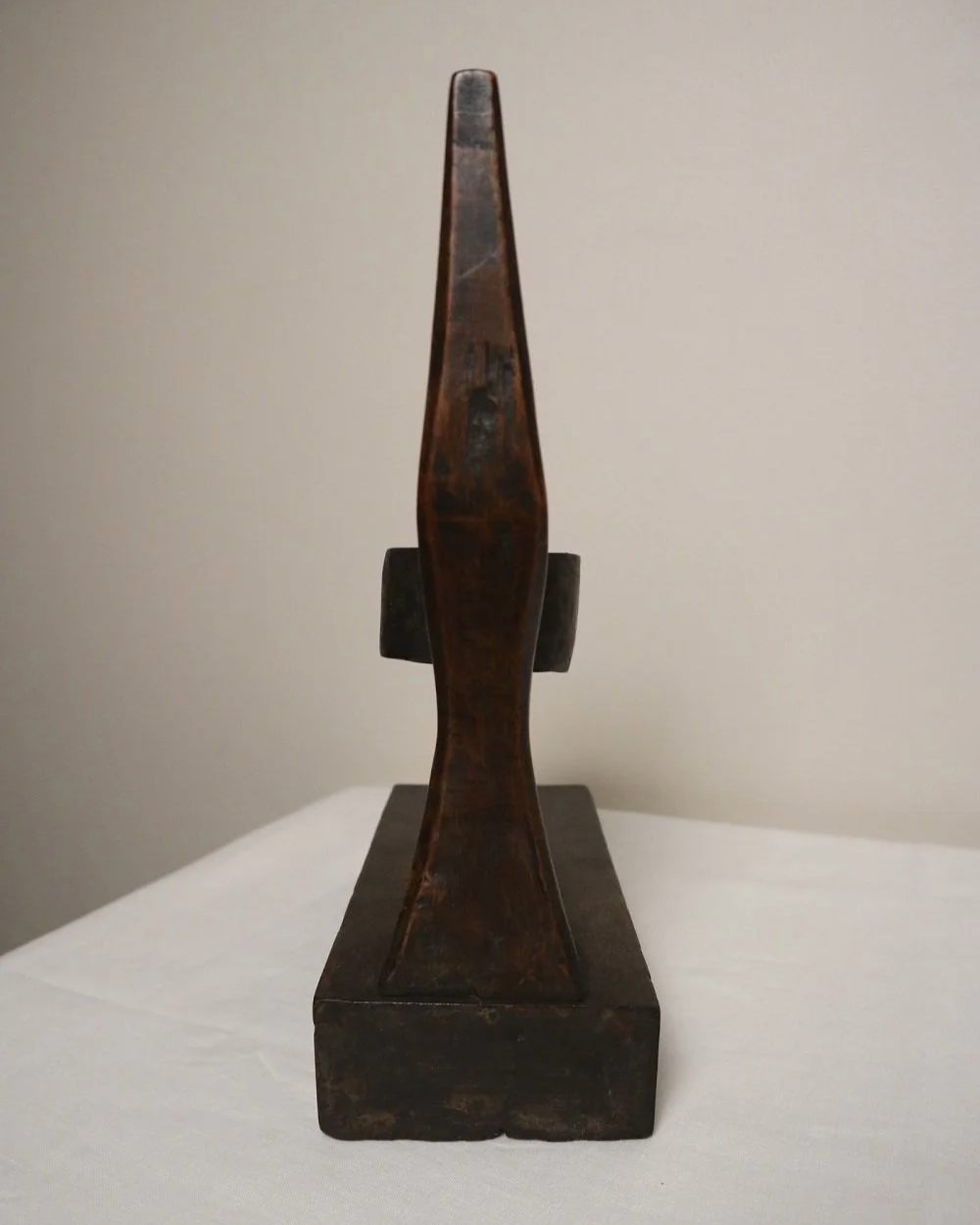 American hand carved dark wooden Brutalist candleholder with block base.