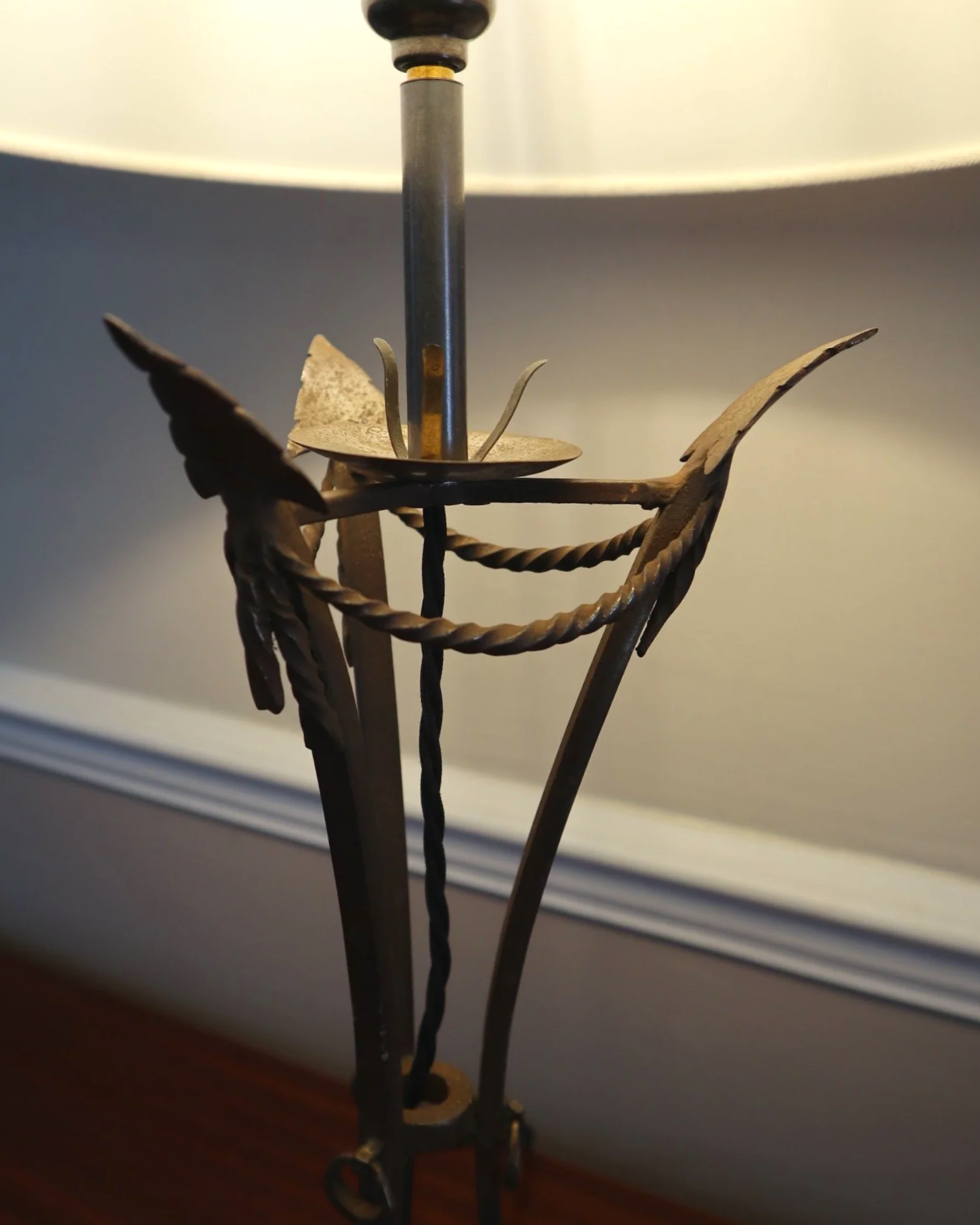 Pair of French style mid century metal tripod table lamps featuring three arrows.