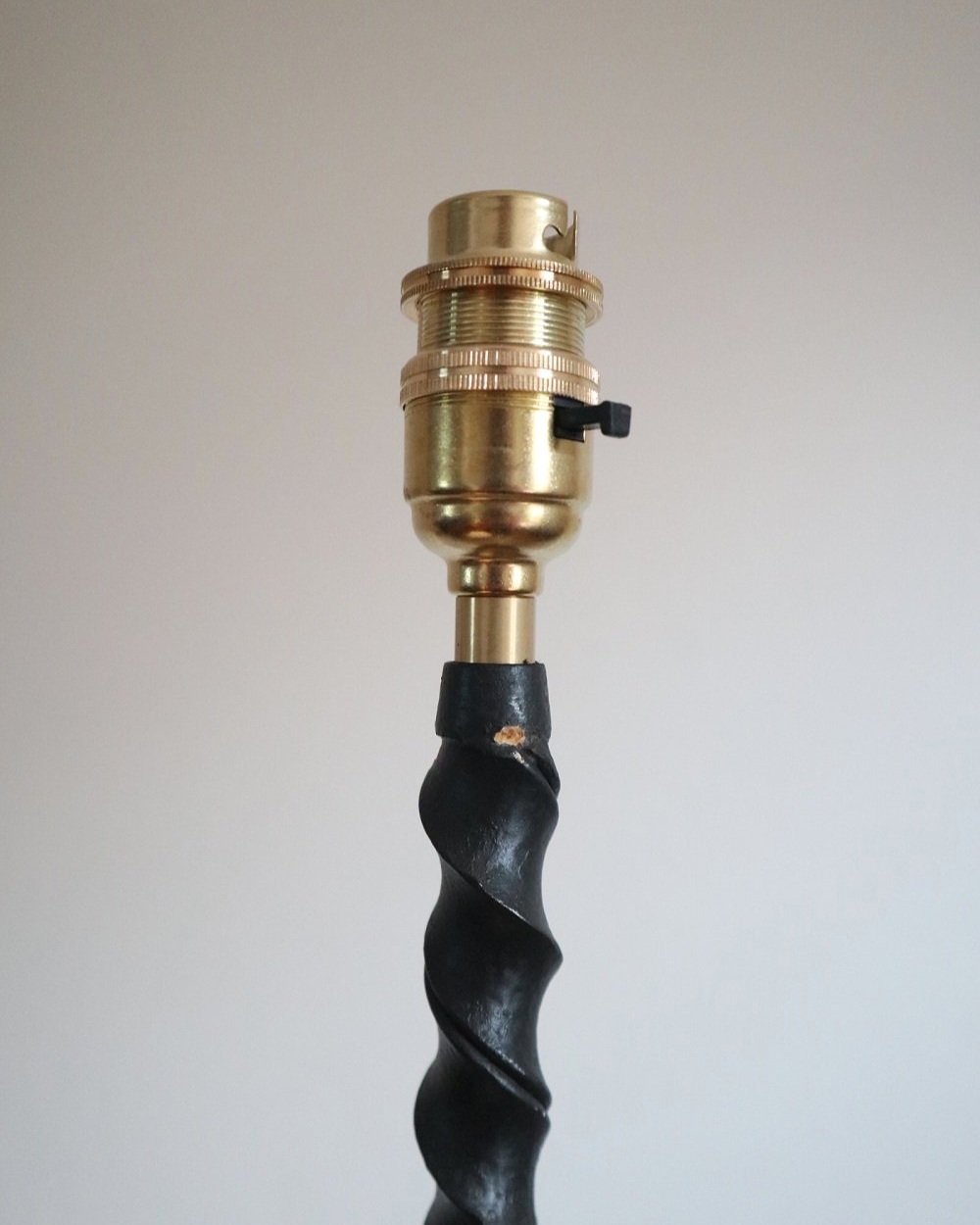French wrought iron floor lamp with twisted corkscrew column and tripod base. Circa 1950s.