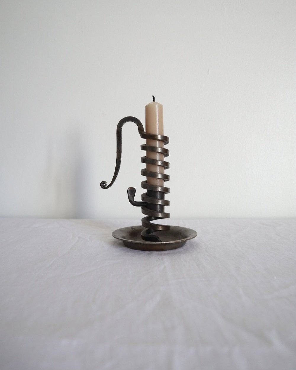 Vintage French 'Rat de cave' iron candleholder with turning spiral mechanism and signature curled handle. Circa 1970s. Marked 'Bourgogne Bouillot 71220 France'.