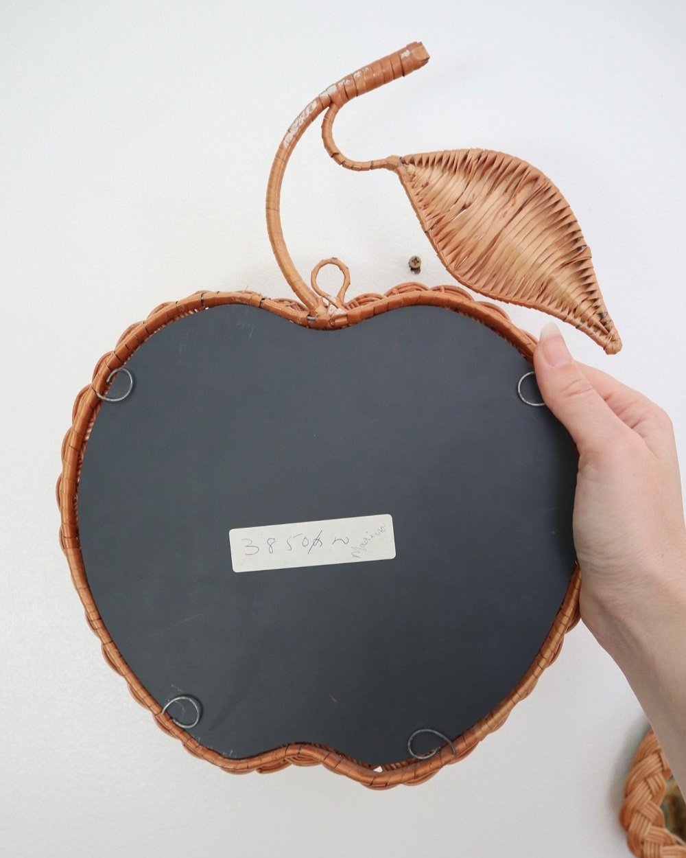 Pair of vintage small wall mirrors in the shape of an apple and a pear, with woven wicker frames.