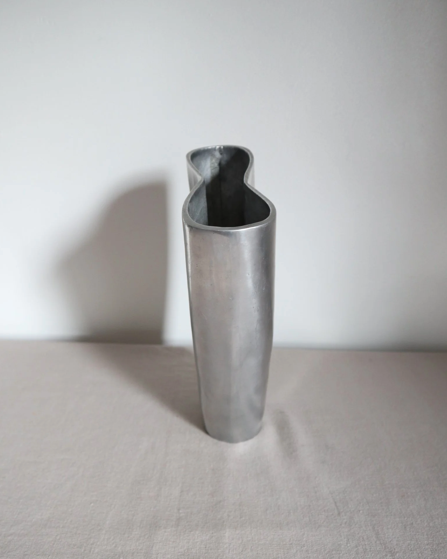 Postmodern heavy cast aluminium vase with sculptural form and four small inset stones. In the style of Anna Efverlund. Circa 1980s. Unsigned.
