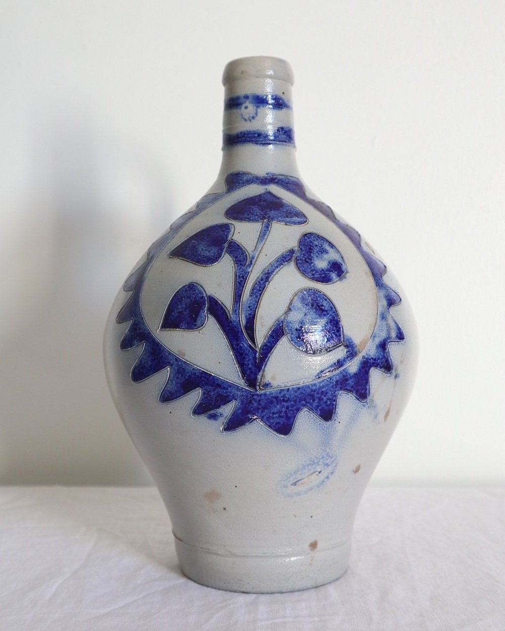 Large vintage German Westerwald salt glazed stoneware flagon with cobalt blue foliage decoration and two bands to the neck.