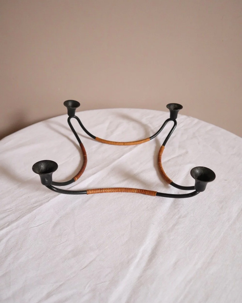Modernist Danish iron and woven rattan four candle holder designed by Laurids Lønborg. Circa 1950s.