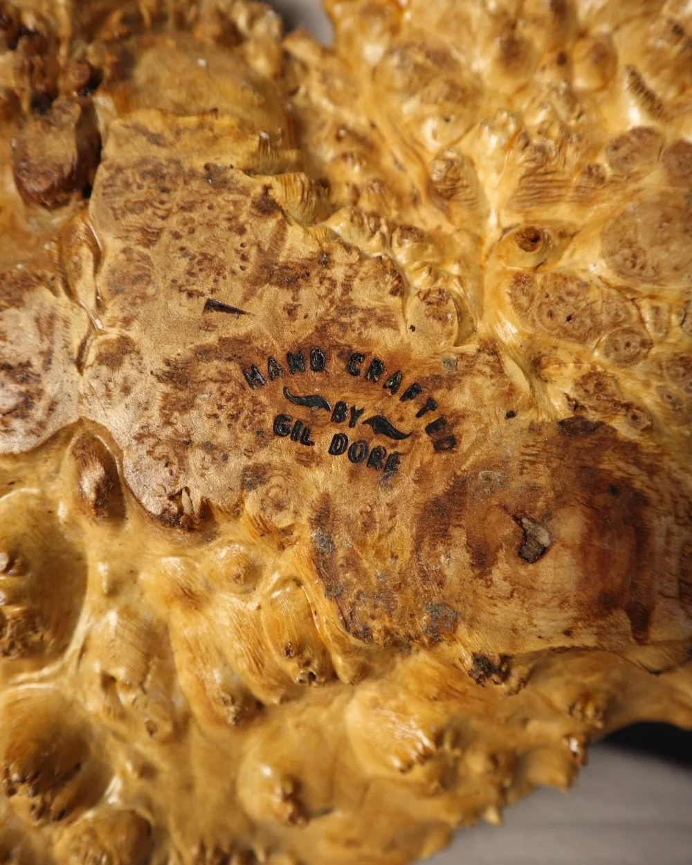 Decorative hand carved golden toned burr wood centrepiece dish with polished centre and organic naturalistic outside.