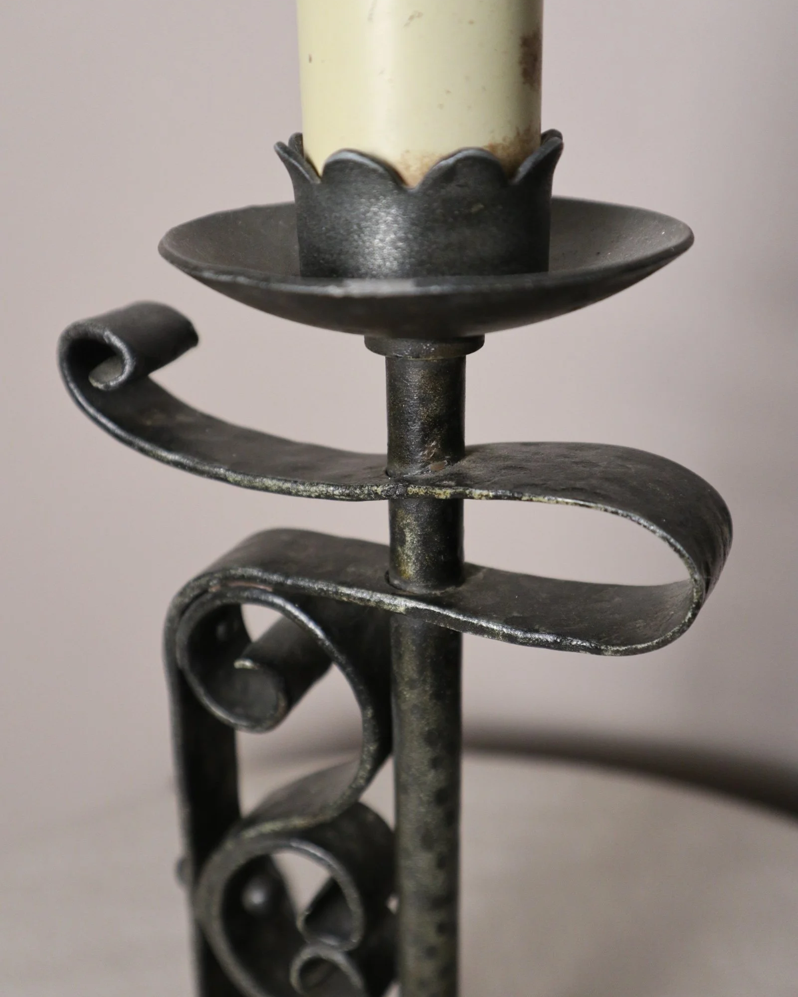 Vintage Art Deco style metal candlestick table lamp with elegant scroll detailing.