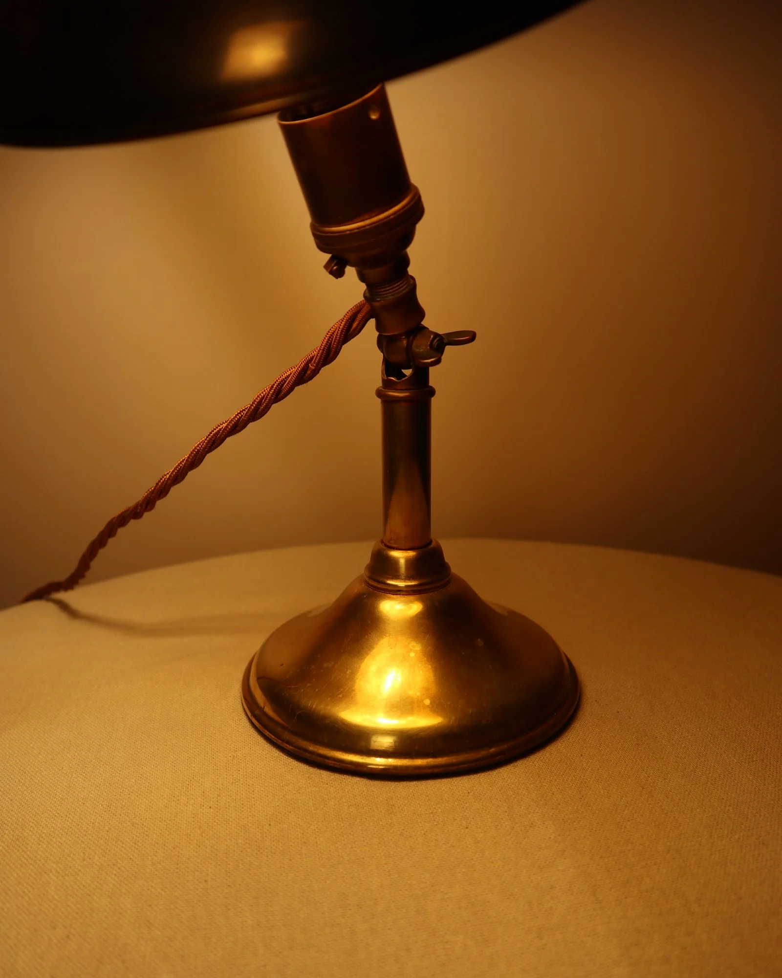 Small, vintage adjustable brass worker's desk lamp. Can be freestanding or attached to the edge of a workbench etc with clamp.