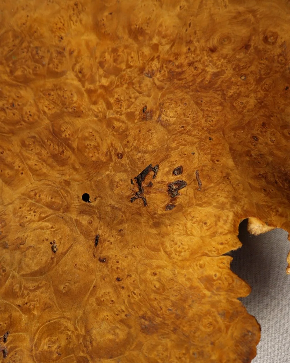 Decorative hand carved golden toned burr wood centrepiece dish with polished centre and organic naturalistic outside.