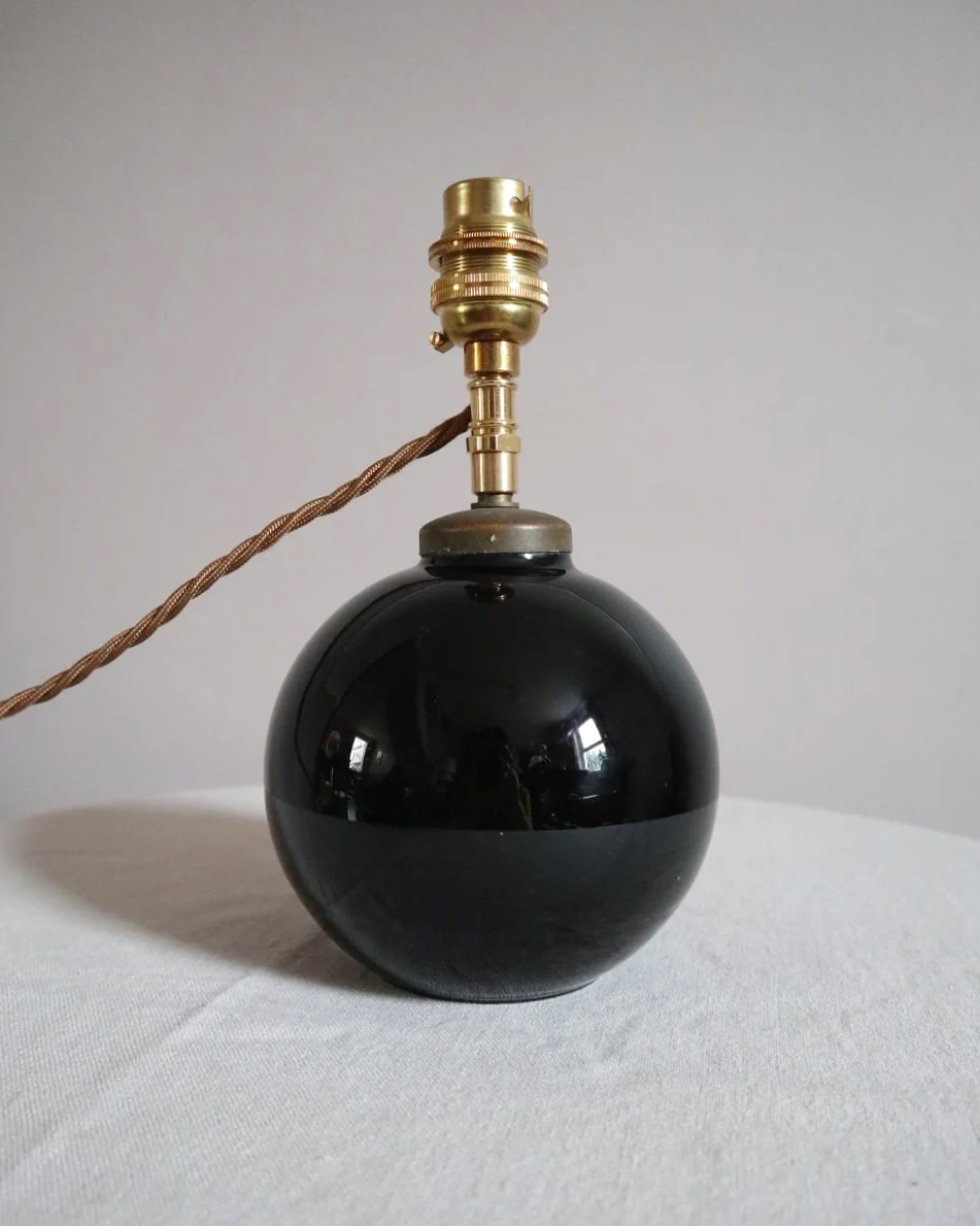 Small, Art Deco black glass ball lamp in the style of Jacques Adnet. Circa 1930s.