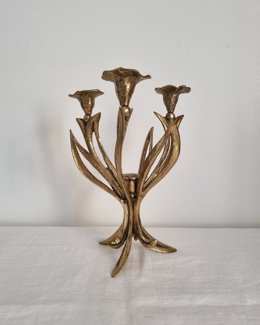 Mid century Art Nouveau style floral heavy brass candelabra with three arms and central candleholder. Circa 1970s.