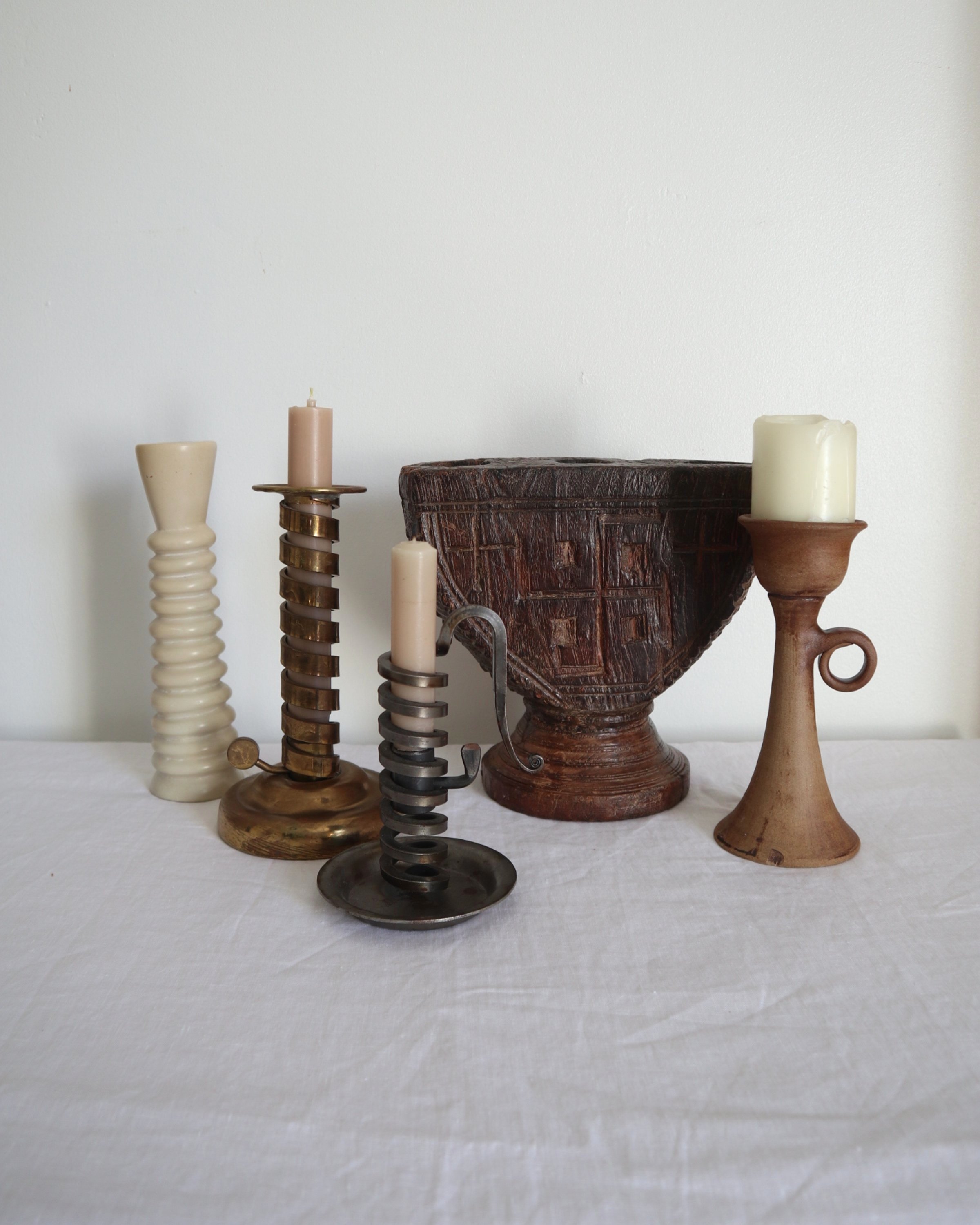 Rustic handmade studio pottery sculptural candleholder with curled circular handle.