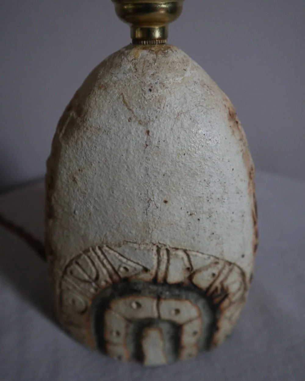 Small Brutalist stoneware table lamp by British potter Bernard Rooke. With stamped, rune-like impressions. Circa 1970s.