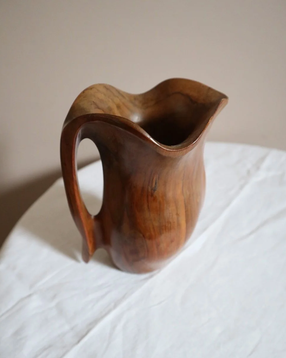 Small mid century hand carved sculptural olivewood jug in the style of Alexandre Noll. Circa 1960s.