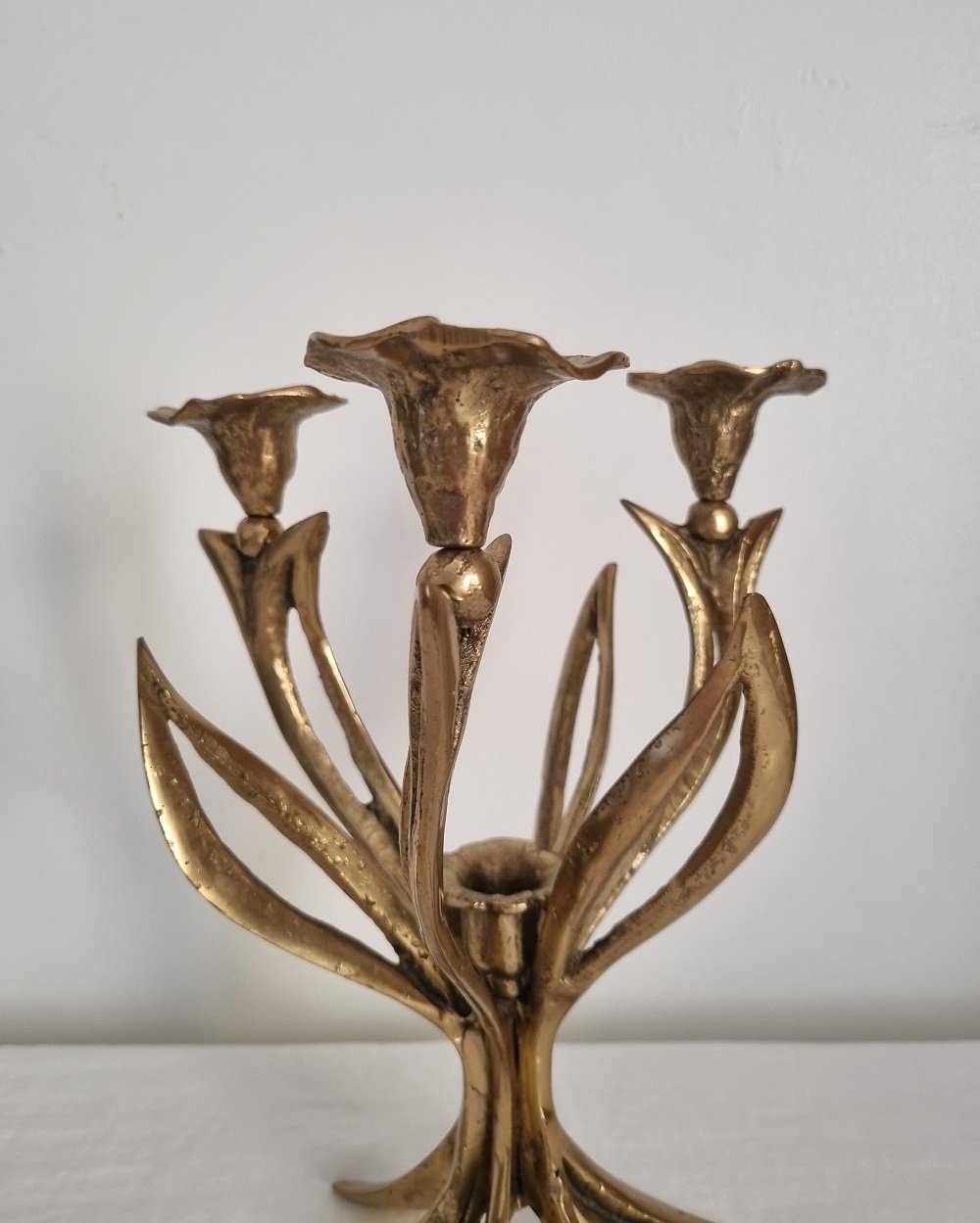 Mid century Art Nouveau style floral heavy brass candelabra with three arms and central candleholder. Circa 1970s.