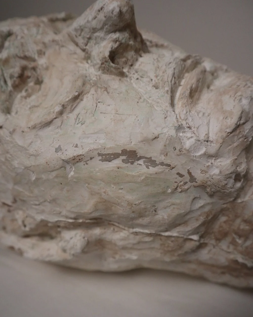 Large, heavy off white textured plaster sculpture of man's head in abstract style. Unknown age.