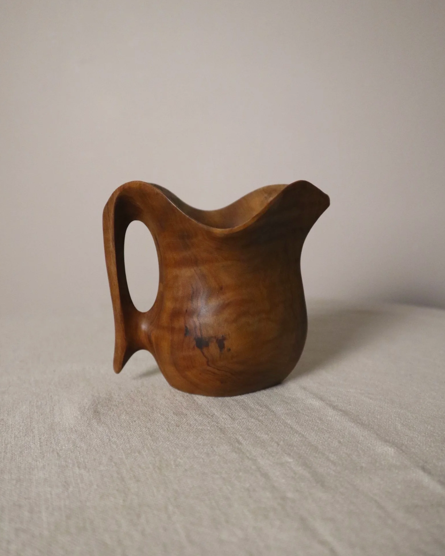 Small mid century hand carved sculptural olivewood jug in the style of Alexandre Noll. Circa 1960s.