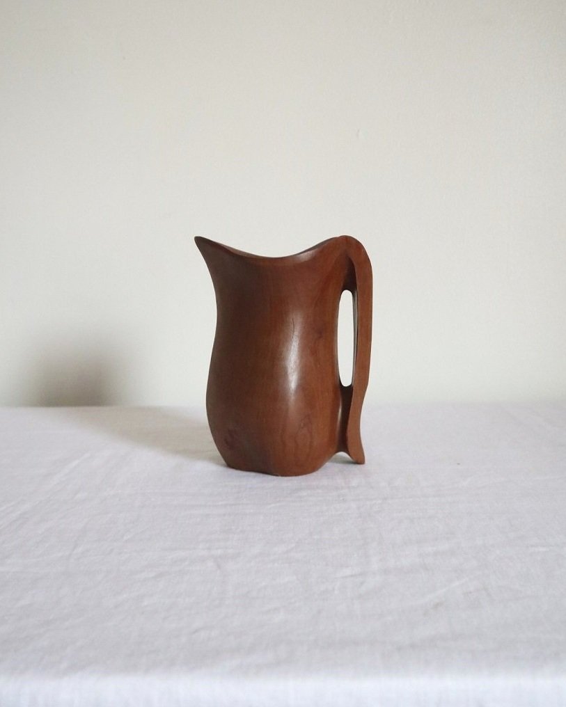 Small sculptural hand carved dark olivewood monoxyl pitcher, circa 1960/70s. In the manner of Alexandre Noll. Unsigned.